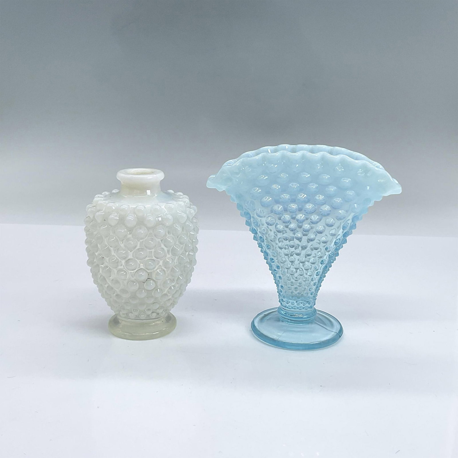 2pc Vintage Mini Opalescent Glass Hobnail Vases: Two small vases with raised hobnail design, white round and blue with ruffle edge. The blue one is taller 4"L x 2"W x 4"H. Dimensions: See Description