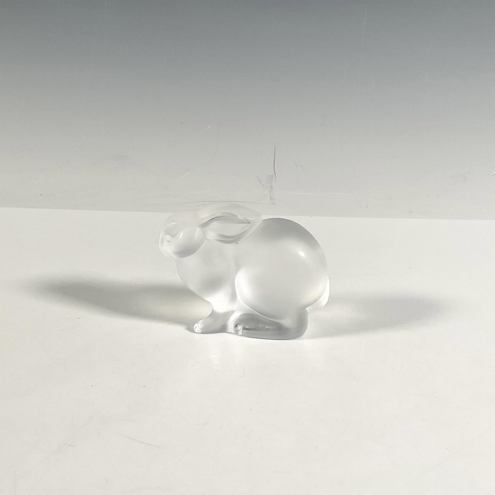 Lalique Crystal Figurine, Bunny Rabbit: Beautiful thick crystal depicting a bunny with clear crystal details. Lalique original stamp and engraved signature. Issued: 20th century Dimensions: 3.5''L x 1.75''W x 3''H Manufacturer: Lalique Coun