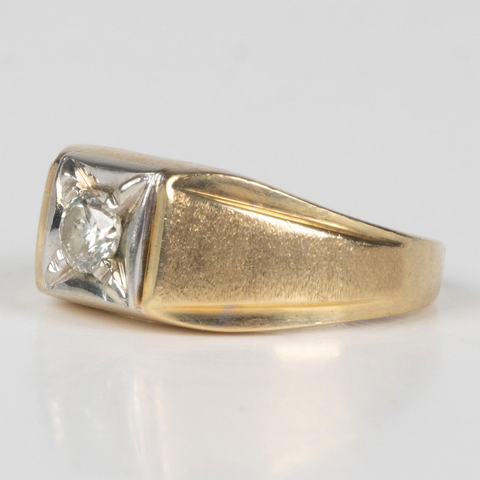 Two-Tone 10K Gold and Diamond Ring: This ring has a yellow gold band and features a 4.5mm diamond set in white gold. Marked 10KP inside the band. Size 8.25, 6g total weight. It comes in a box that measures 1.75"L x 2"W x 1.5"H. Dimensio