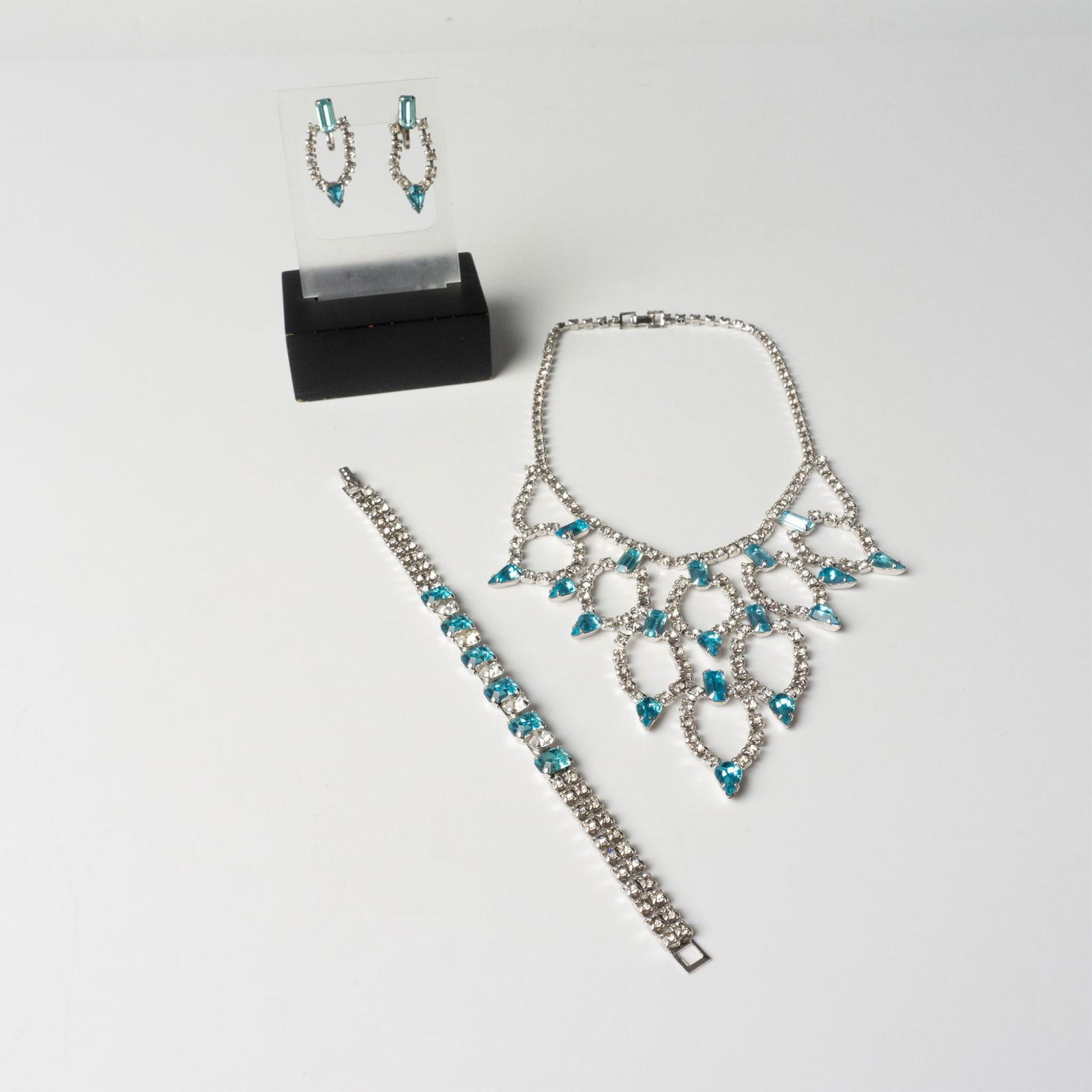 3pc Sparkling Silver Metal and Rhinestone Jewelry Set: Silver tone necklace, bracelet, and screw-back earrings with brilliant clear and light blue rhinestones. The earrings are not for pierced ears. The choker necklace measures approximately 14"L with a f