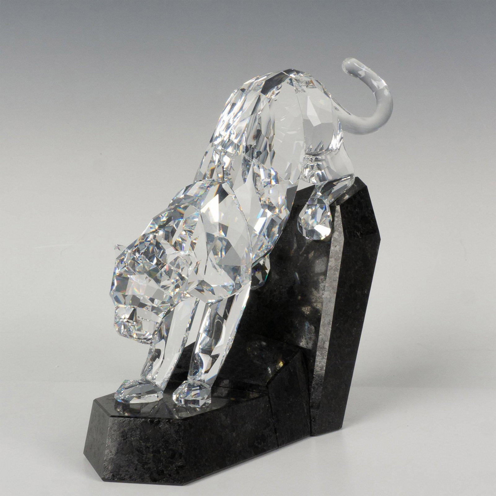 Swarovski Crystal Figurine, Soulmates - Panther: Part of the Soulmates theme group this piece symbolizes the power and majesty of this animal. Figure is created of clear faceted crystal about to leap from a granite base covered with protective felt 