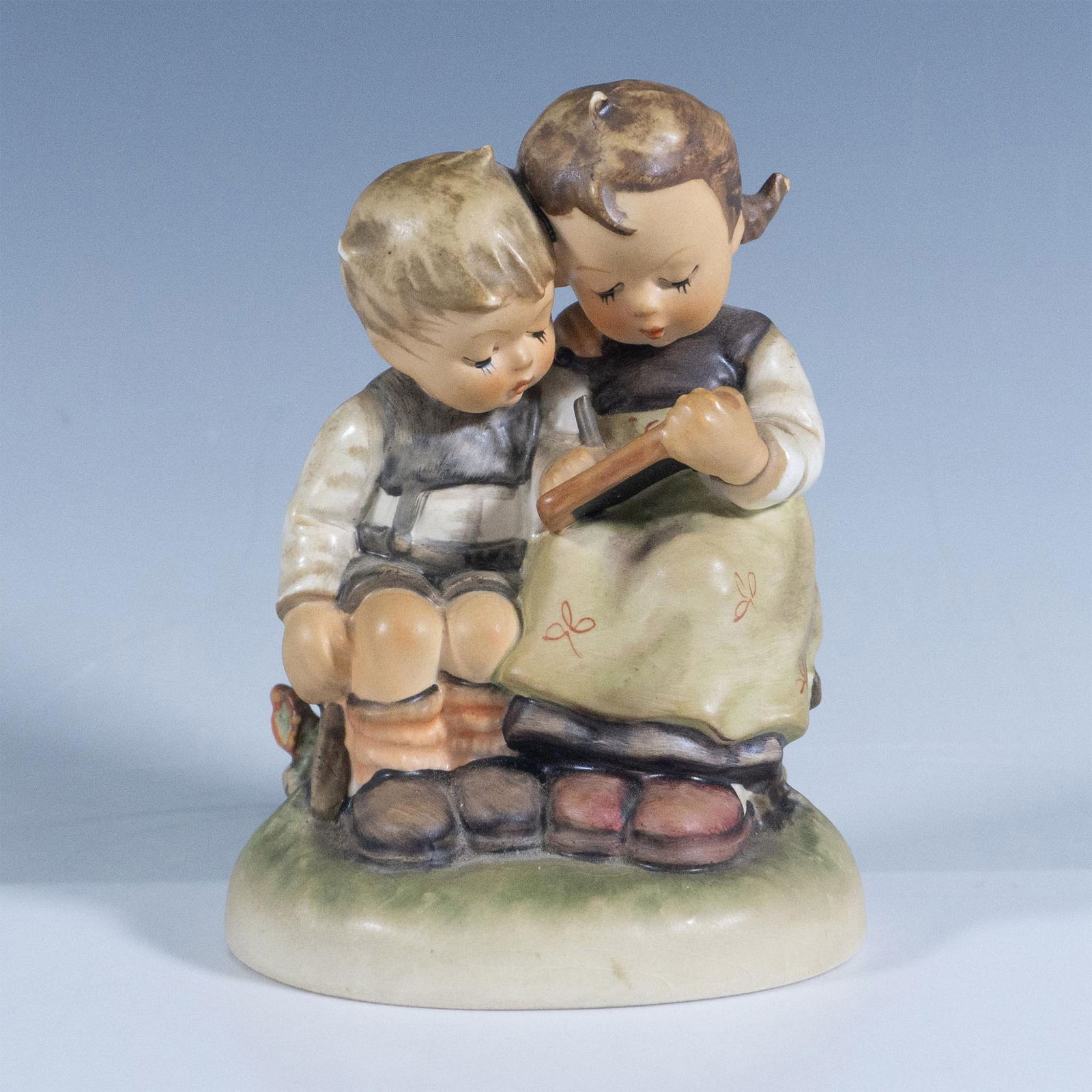 Goebel Hummel Figurine, The Smart Little Sister 346: Matte finish. Depicts two children on learning session. Goebel backstamp. Artist: M. I. Hummel Issued: 1956 Dimensions: 3''L x 3.25''W x 4.5''H Manufacturer: Goebel Hummel Country of Origin: Germ