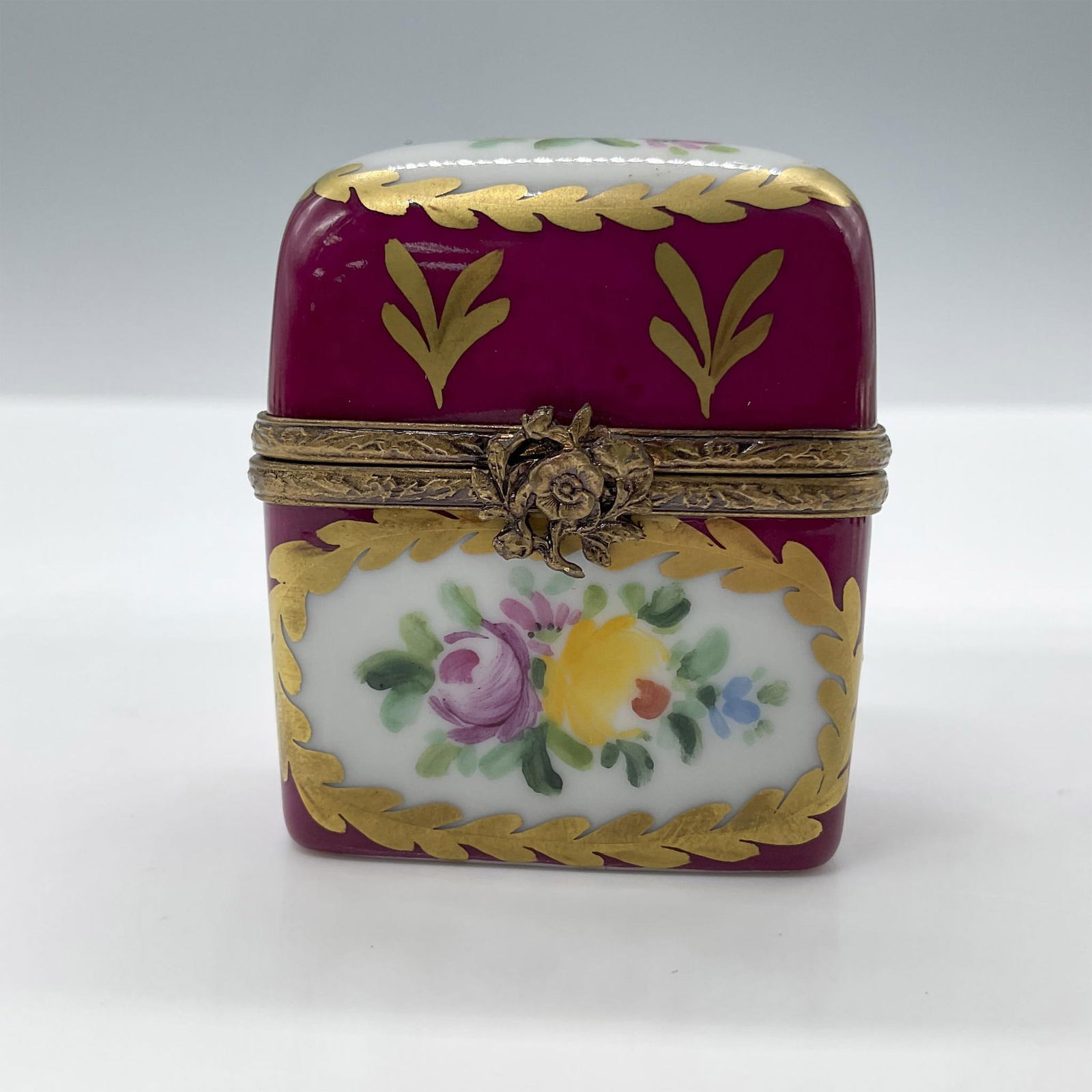 Limoges Porcelain Treasure Box, Red Chest: Hand painted in Limoges France. Limited edition. A little chest with painted flowers, gold accents and a metal flower closure. Signed Peint Main Limoges France MB gg 26/50 LL. Issued: 1999 Dimensions: