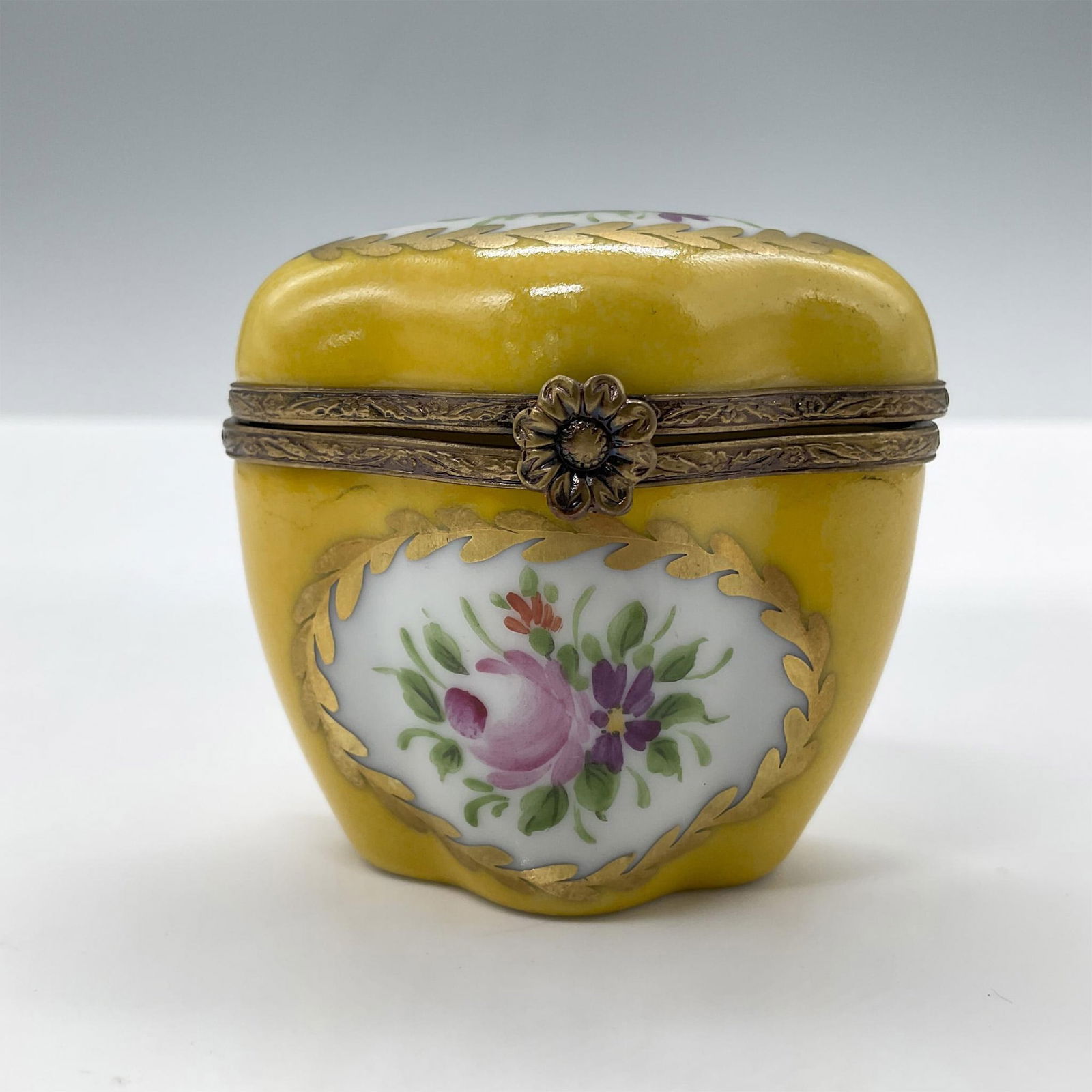 Limoges Porcelain Treasure Box, Yellow Chest: Hand painted in Limoges France. Limited edition. A little chest with painted flowers, gold accents and a metal flower closure. Signed Peint Main Limoges France MB gg 3/50 LL. Issued: 1999 Dimensions: