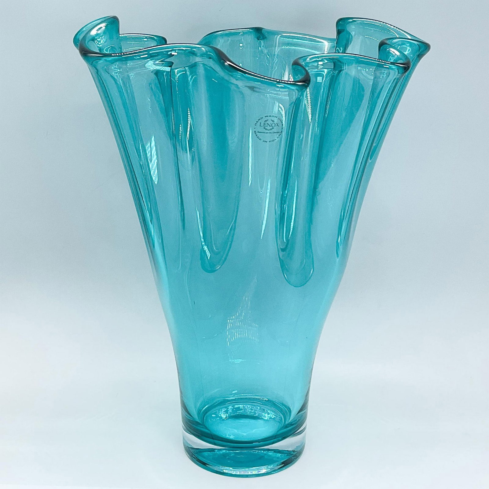 Lenox Turquoise Glass Ruffled Vase: Vibrant turquoise glass vase in a ruffled design with a clear base. Lenox affixed label. Dimensions: 9.5"L x 9"W x 12"H Manufacturer: Lenox Country of Origin: Poland