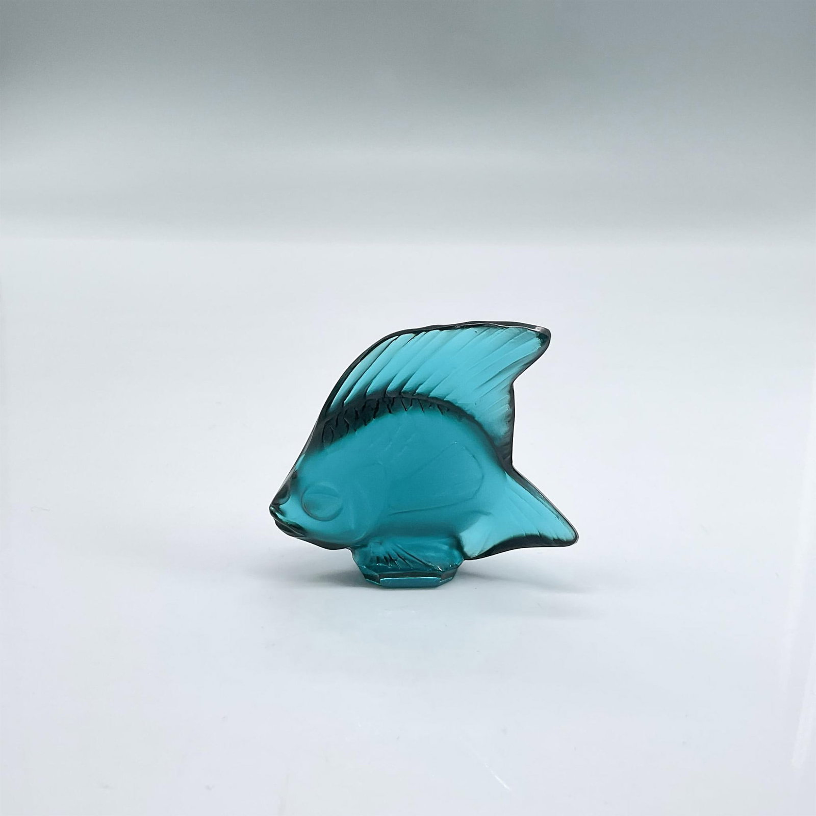 Lalique Satin Crystal Figurine, Fish, Dark Turquoise: Figure of a fish in satin and clear deep turquoise glass. Lalique France etched mark. Dimensions: 2"L x 0.75"W x 1.75"H Manufacturer: Lalique Country of Origin: France