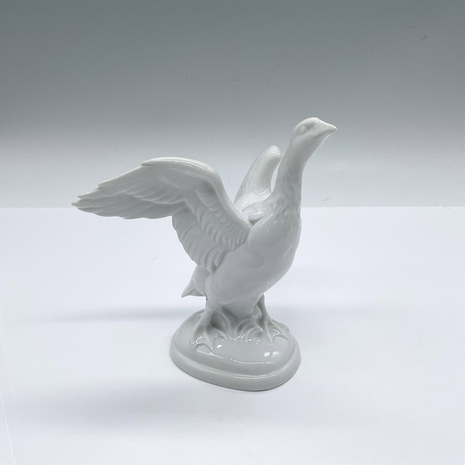 Rosenthal by O Obermaier Porcelain Bird Figurine, Goose: All white animal figure of a farm bird with wings spread out. Rosenthal green underglaze mark. Artist: O. Obermaier Issued: 1919-1935 Dimensions: 4.25"L x 4.5"W x 5.25"H Manufacturer: Rosenthal Count