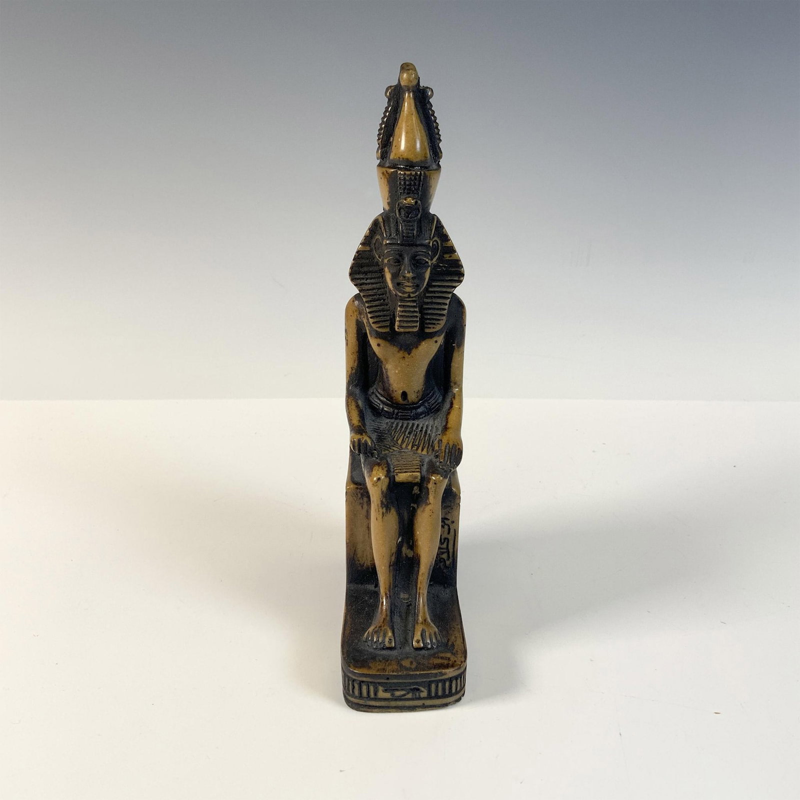 Stoneware Statue of Ramses II Enthroned: Statue is a nod to Ancient Egypt's documentation of their Pharaohs. Ramses II reigned over greater Egypt from 1279–1213 BCE. Unmarked. Issued: 20th century Dimensions: 1.75"L x 3.75"W x 8"H