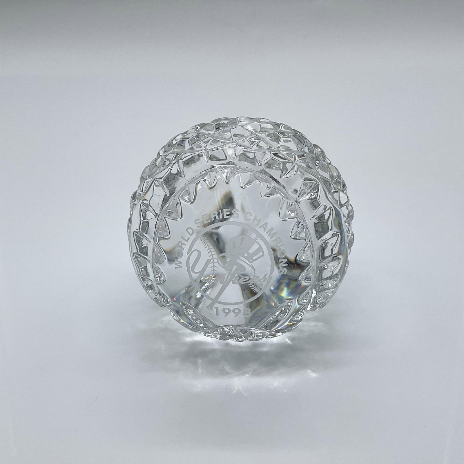 Waterford Crystal Paperweight, Yankees World Series Baseball: Clear with crisscross and diamond cut motifs. Etched Yankees World Series Champions Subway Series 1998. Trademarked to underside. Numbered 1176 of 5000. Issued: 1998 Dimensions: 2.75"W x 2.5"H Edition