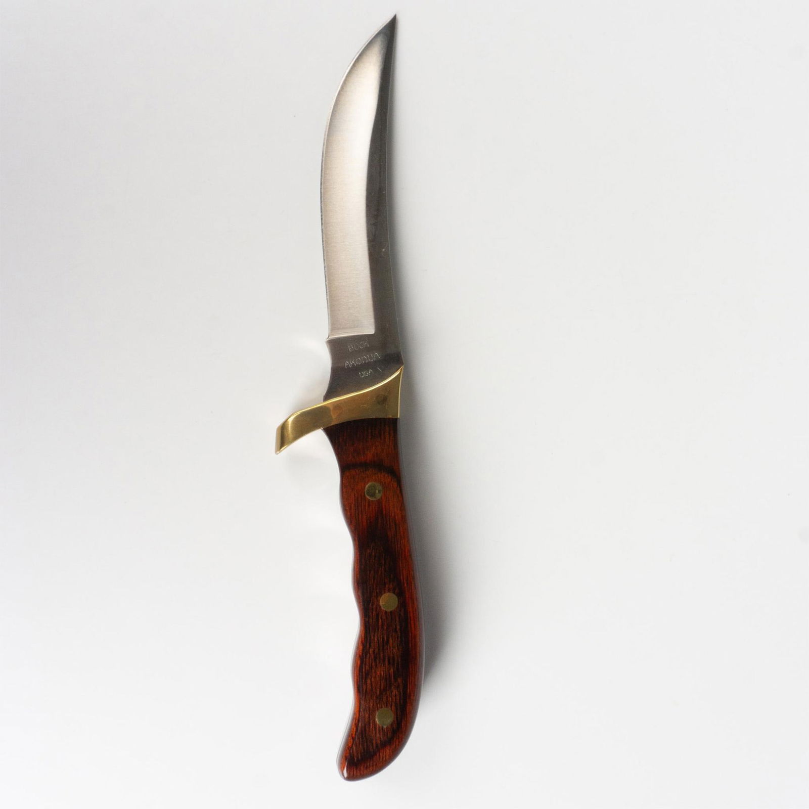 Buck Akonua Fixed Blade Knife with Wood Handle: A collaboration between Buck and the Akonua tribe of Afrika, this gorgeous knife features an exposed full tang and brass metal cross guard with polished wood scales. Blade is just over 4.75" in length