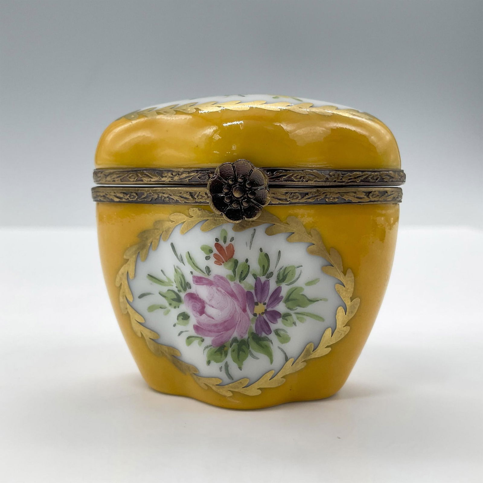 Limoges Porcelain Treasure Box, Yellow Chest: Hand painted in Limoges France. Limited edition. A little chest with painted flowers, gold accents and a metal flower closure. Signed Peint Main Limoges France MB gg 15/50 LL. Issued: 1999 Dimensions: