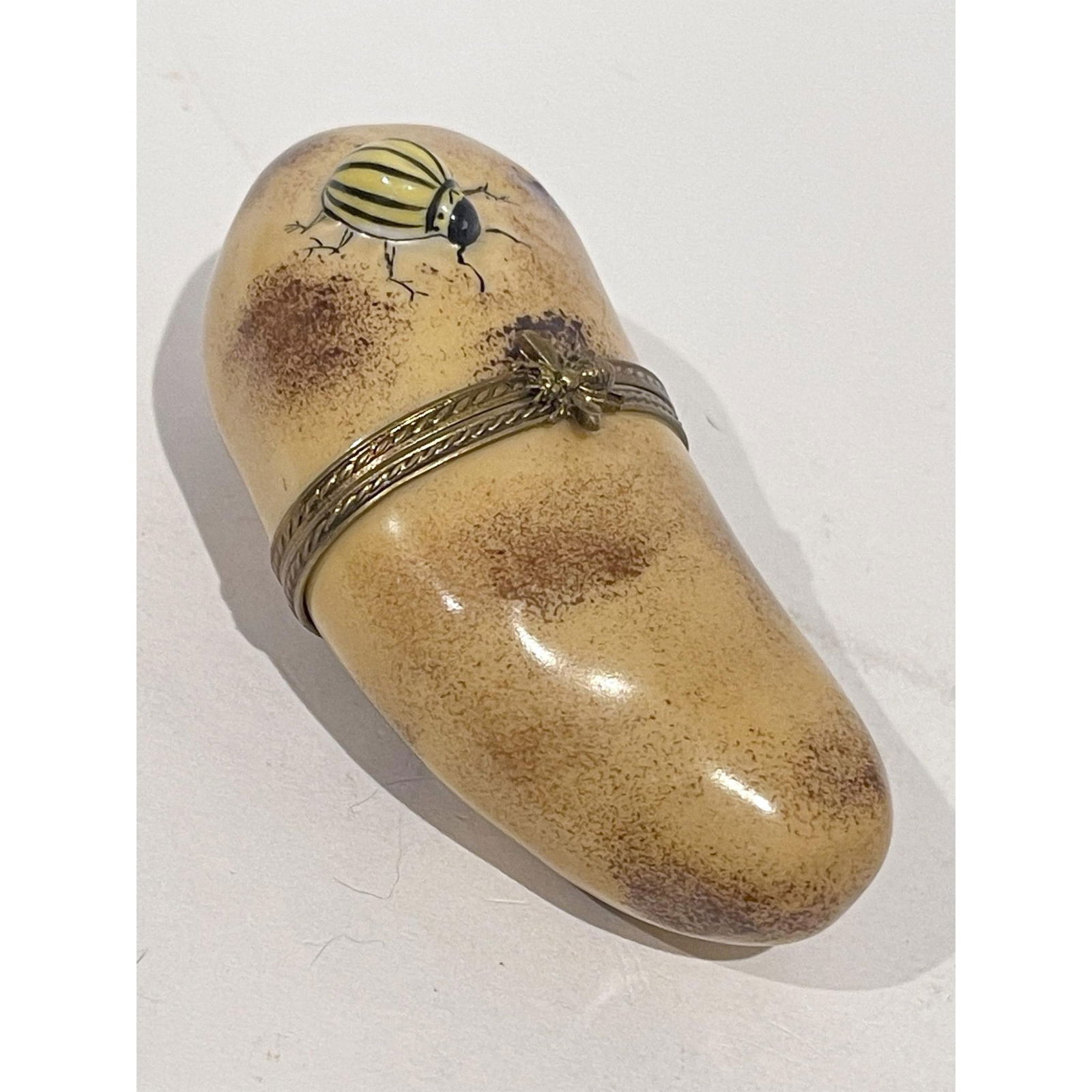 Limoges France Keepsake Box, Potato with Colorado Beetle: Realistically hand painted Brown potato replete with authentic Colorado potato beetle in tow mini Box with gilded bee at hinge opens to white interior. France MB GU Peint Main Limoges backstamp inside
