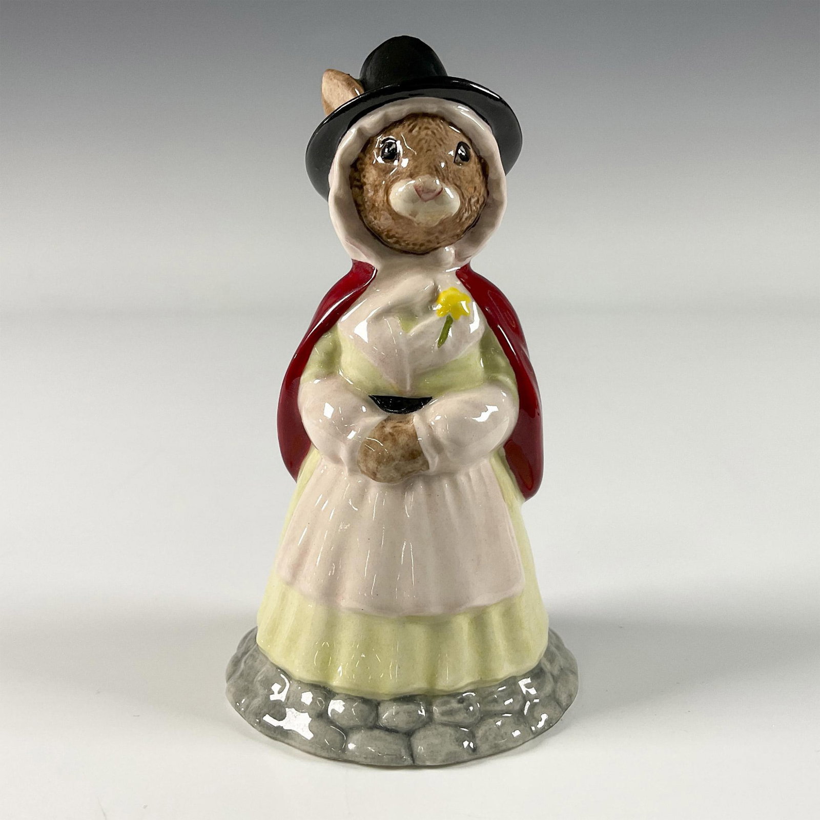 Welsh Lady DB172 - Royal Doulton Bunnykins: A figure of a female dressed in historical clothing, adorned with a red cape and black top hat. Royal Doulton backstamp. Artist: D. Andrews Issued: 1997 Dimensions: 5"H Edition Number: 1719 of 2500 M