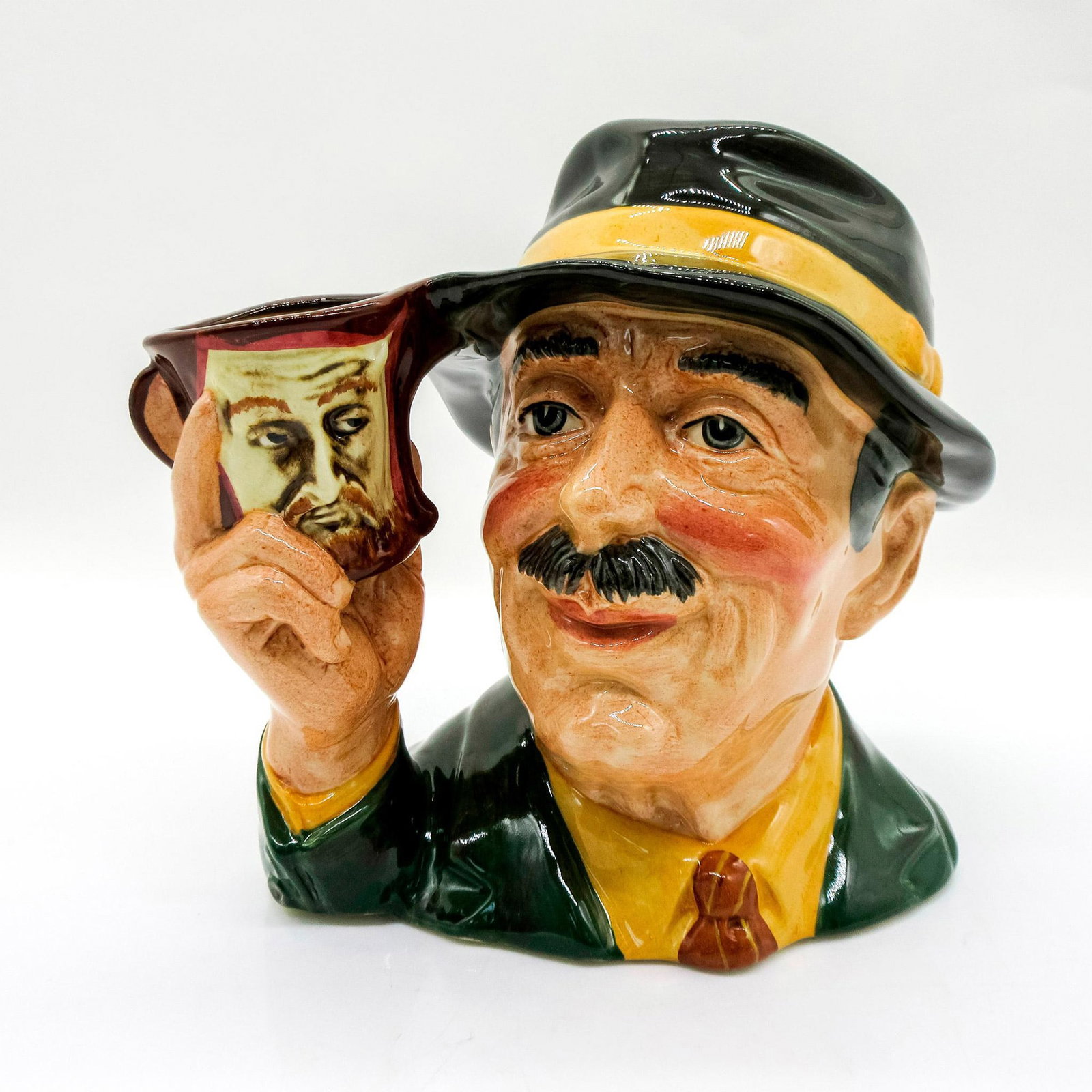 Collector D6796 - Large - Royal Doulton Character Jug: Variation One. Black hat, dark green jacket, tan shirt. Series: The Collecting World. Royal Doulton backstamp. Comes with certificate. Artist: Geoff Blower Issued: 1988 Dimensions: 7"H Manufacturer: R