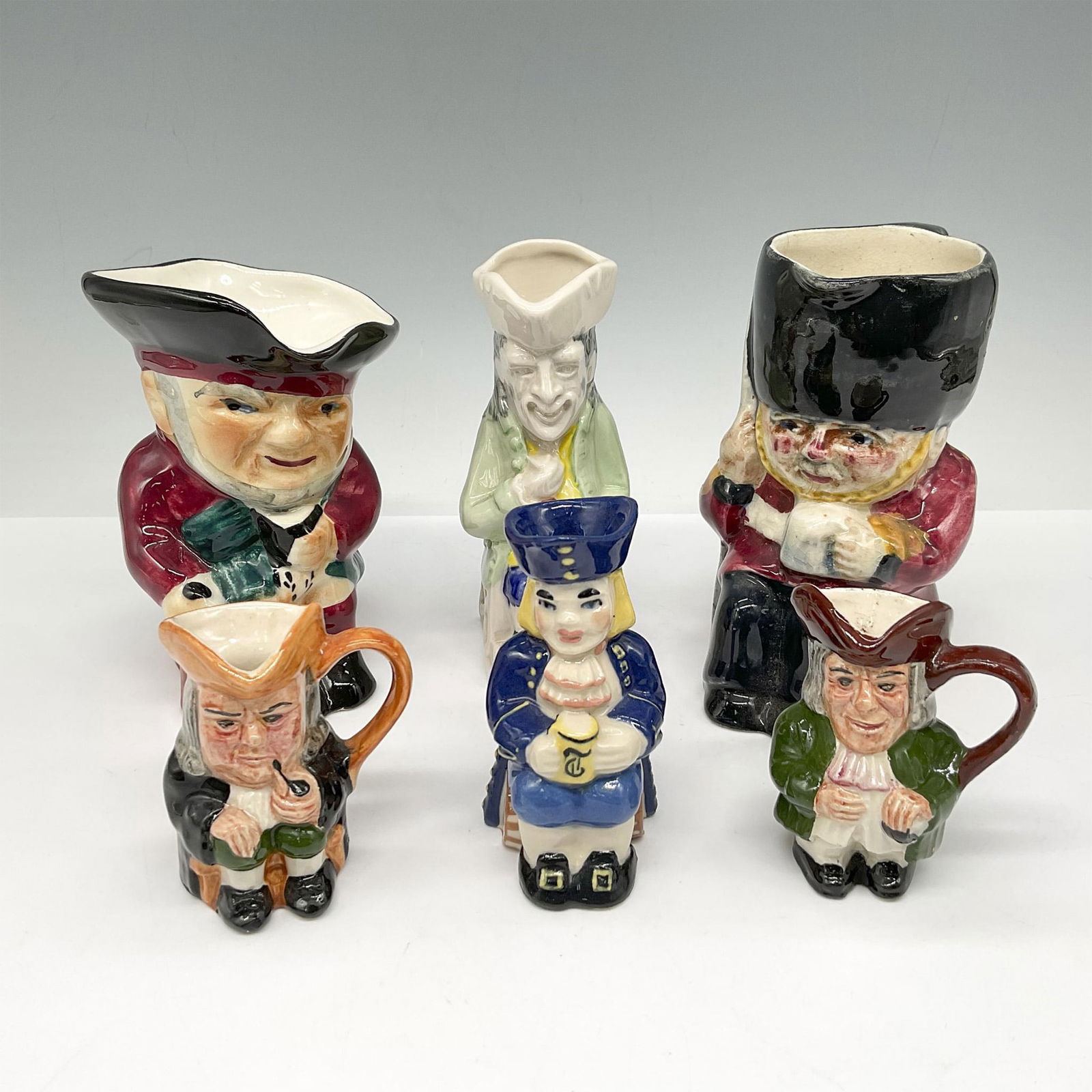 6pc Mixed Lot of Ceramic & Porcelain Toby Jugs: Lot includes Artone 2 Mini Jugs 2.5"H, Ceramic Art Studio 3.25"H, 2 Shorter & Sons 4.5"H and Kevin Francis Collection 4.25"H. All have backstamps. Largest piece: 3"L x 4.25"W x 4.5"H. Issued: 20th cen