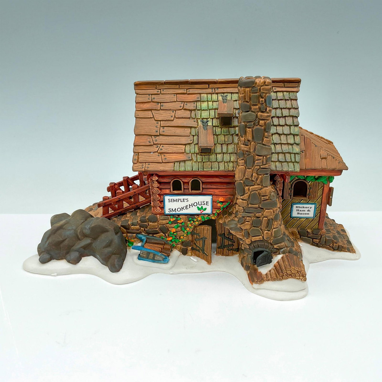 Dept 56 Heritage Village, Semple's Smokehouse Lighted: Part of the New England Village Series. Hand-painted porcelain, depicting stone and log smokehouse This item has its original box which measures 12"L x 7"W x 7"H. Department 56 backstamp on base. Ligh