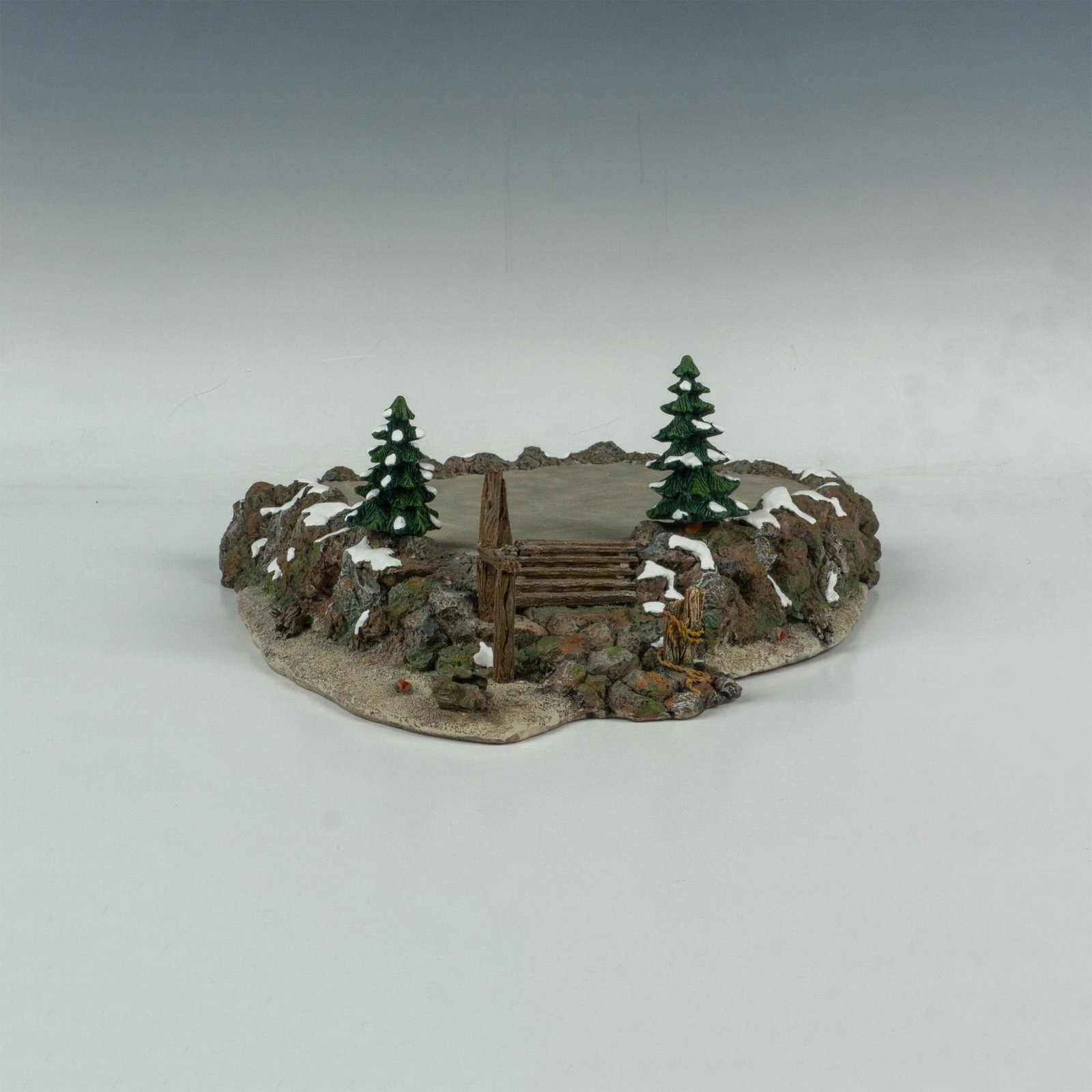 Department 56 Village Accessories, Craggy Cliff Platform: Detailed ceramic platform designed with rocks, trees and flat platform. This item has its original box: 16.5"L x 4.5"W x 16"H. Issued: c.1999 Dimensions: 14"L x 14"W x 5.5"H Manufacturer: Department 5