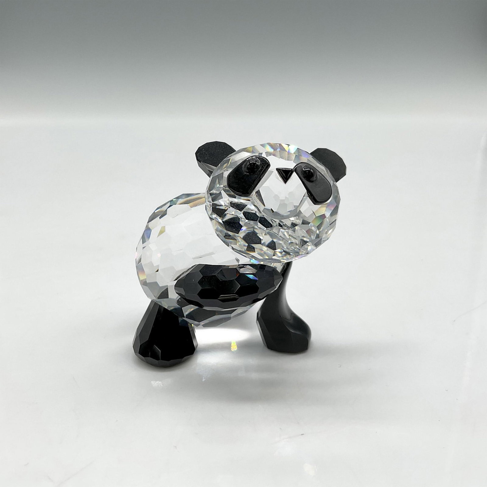 Swarovski Silver Crystal Figurine, Panda Mother: Part of the Rare Encounters Collection this clear faceted crystal figure has jet crystal ears, paws and eyes. Swarovski backstamp. 7611 000 001. 181080. This item has its original box: 5"H x 3" dia. A
