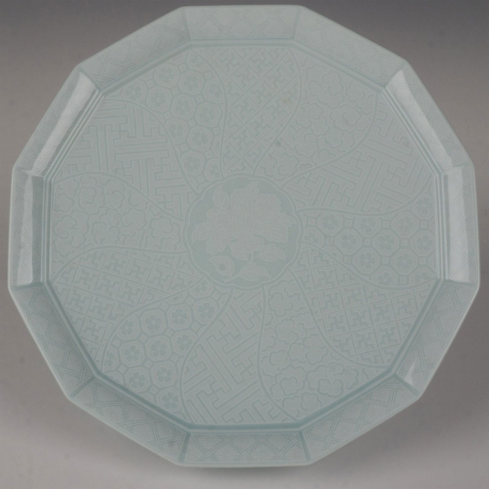 Noritake-Style 12-sided Japanese Serving Platter: This stunning platter is glazed in a celadon color and decorated with various floral and geometric patterns. This item has its original box which measures 12.75"L x 12.75"W x 2"H. Dimensions: 12"L x 1