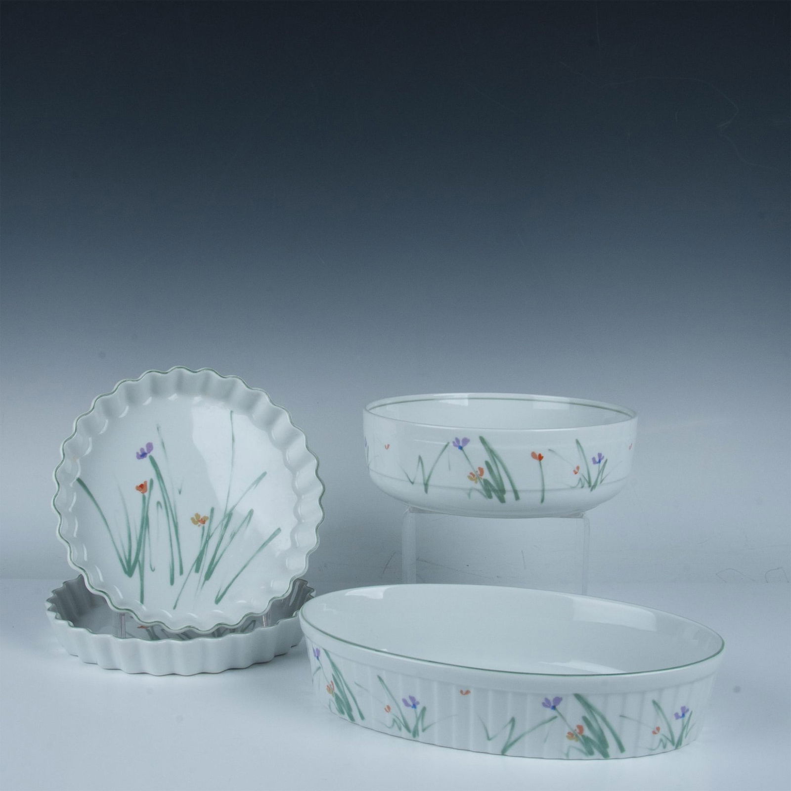 4pc Mikasa Porcelain Serveware Dishes, Sketchbook: Four oven-safe serveware dishes in a sketch-like design of purple, coral and orange flowers with green lines representing foliage. Mikasa backstamp. Longest oval dish is 12"L x 7.5"W x 2.5"H. Large ro