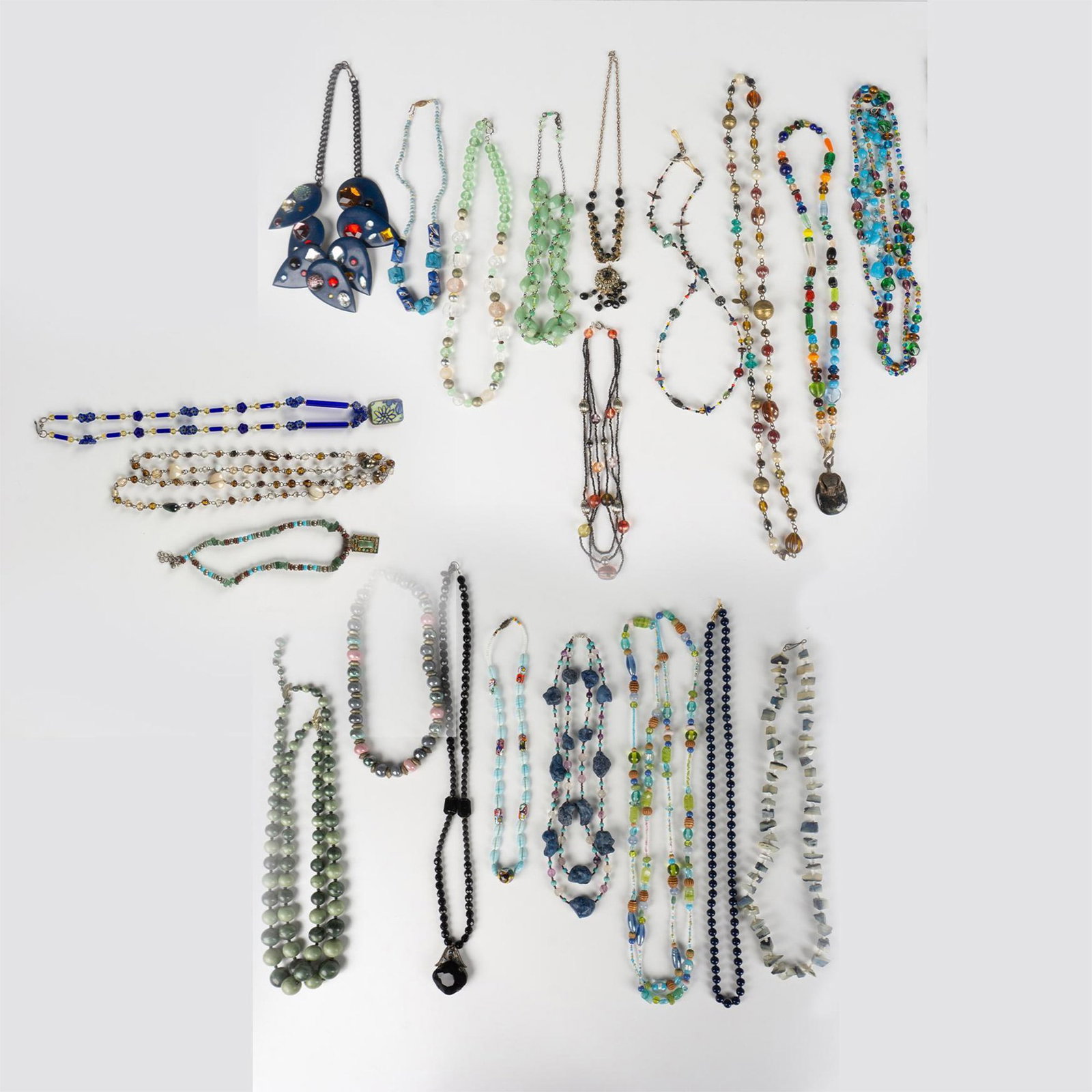 25pc Lot of Unique Necklaces: Twenty five beautiful single and multi-strand necklaces. The longest measures approximately 60.5"L. Dimensions: See Description