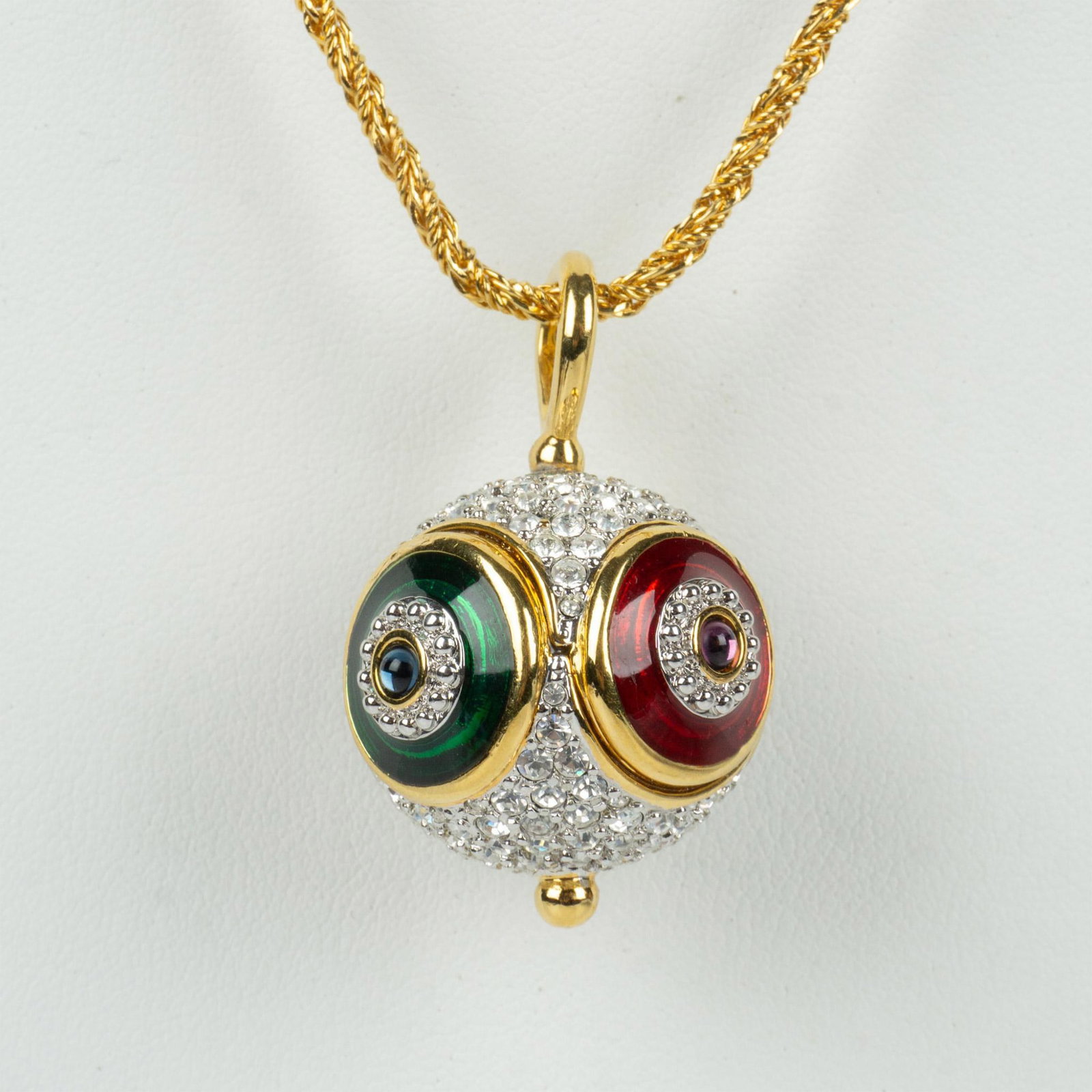 Swarovski Crystal Art Deco Orb Pendant Necklace: Gold metal chain and pendant with enamel and crystals. The pendant measures 1.5"L x 1"W and the chain measures 33.5"L. Swarovski hallmark on the clasp. Dimensions: See Description Manufacturer: Swarov
