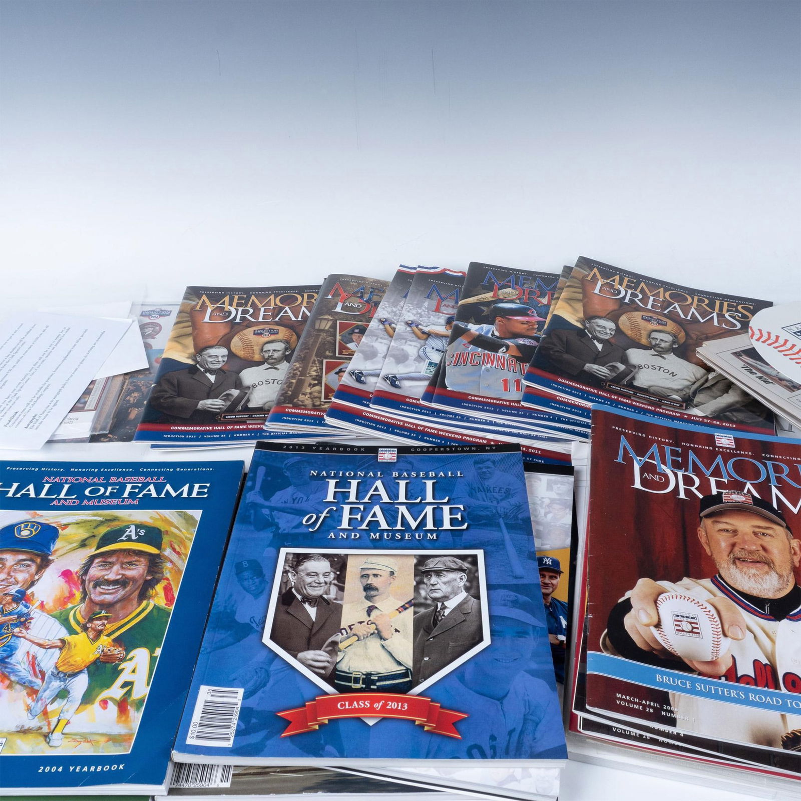 Lot of 40+ Baseball National Hall of Fame Memorabilia Grouping: This great collection of Hall of Fame memorabilia includes programs spanning decades from the 1980's to 2014 along with various signed pieces, tickets, promotional fan, and Cooperstown newspapers. The