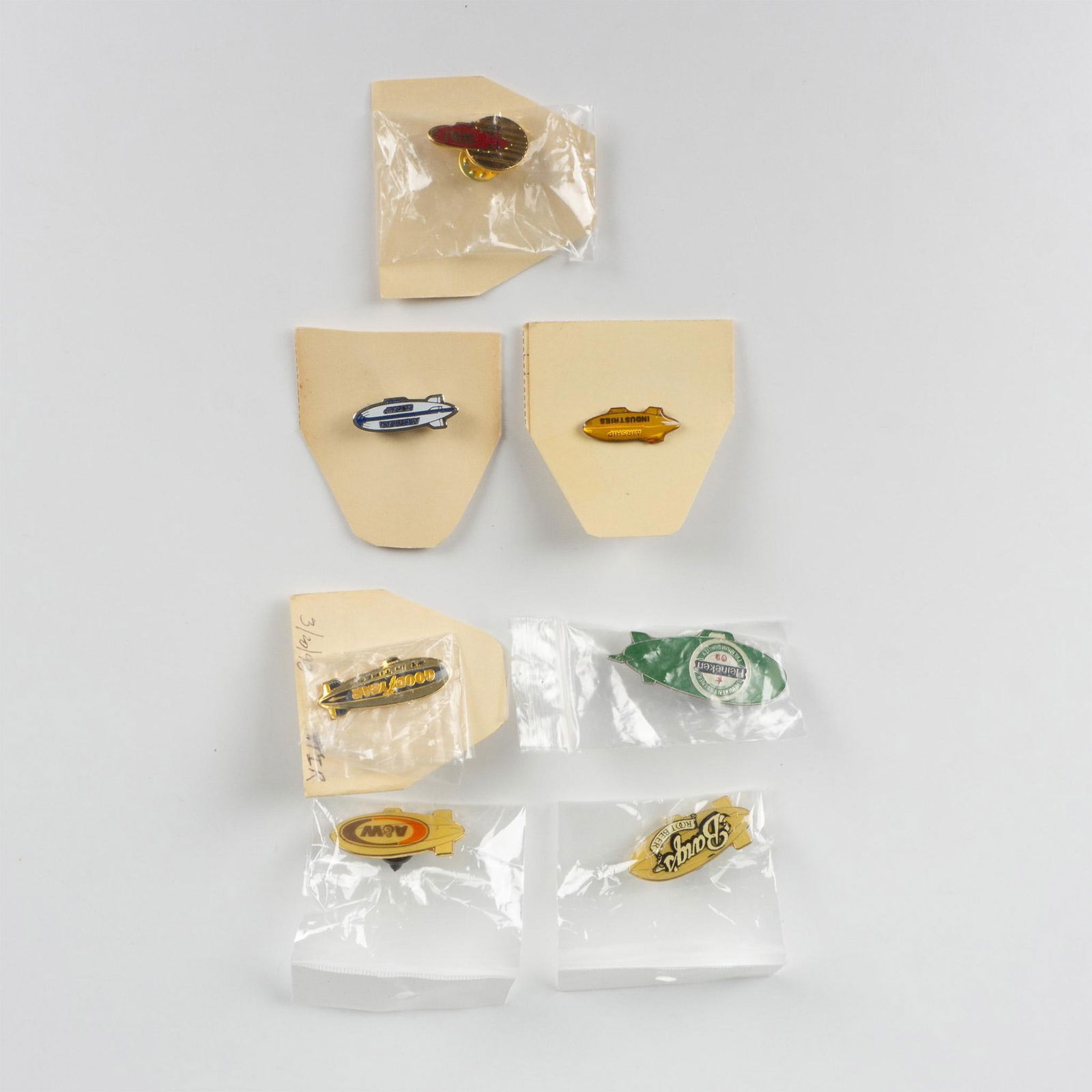 7 Original Commemorative Zeppelin Advertisement Pins: Group of seven original commemorative Zeppelin advertisement pins that includes: Barq's Root Beer; A&W; Airship Industries; Heineken; Goodyear; WAI; and Airstream Skyship. Average size: 1.50"L x 0.50"