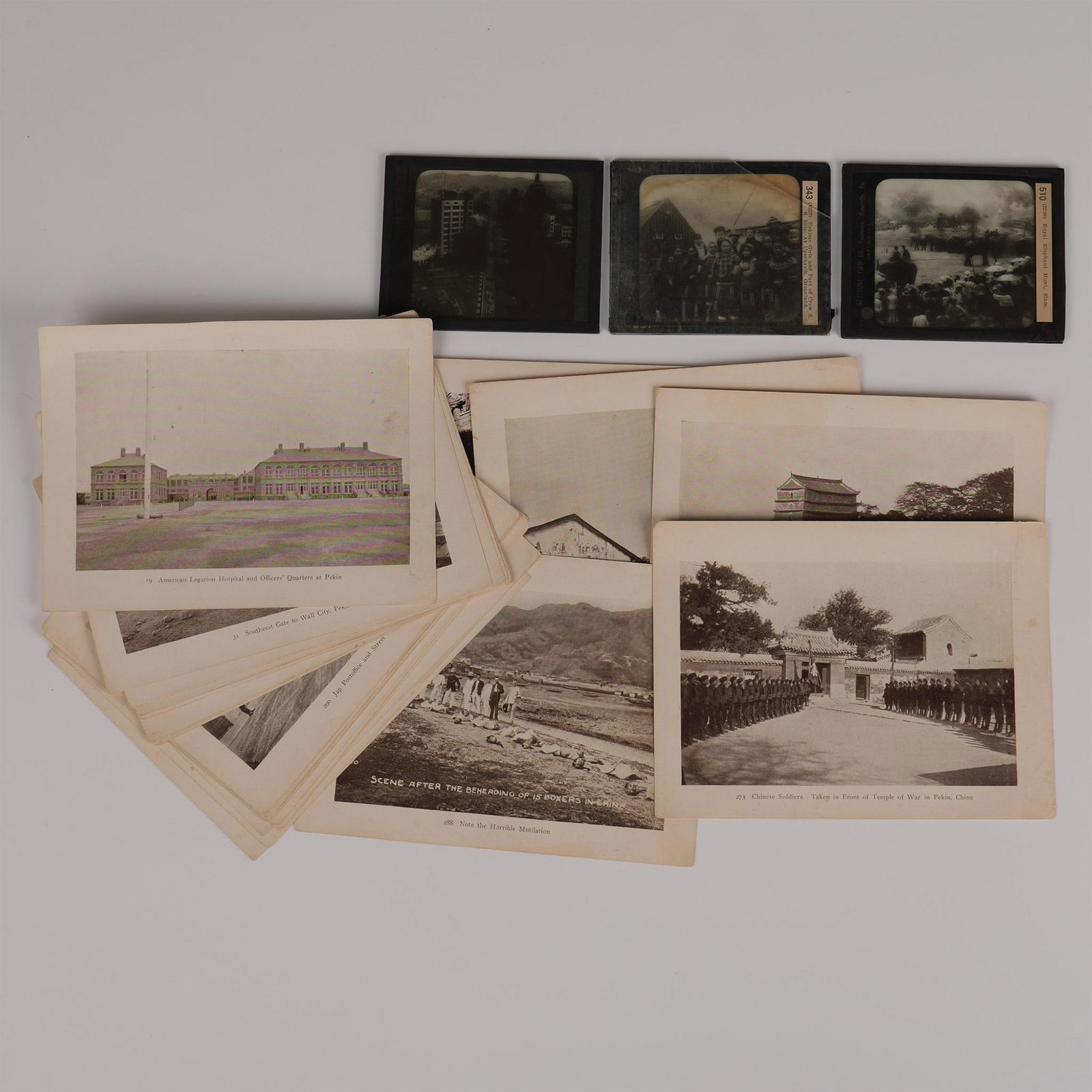 Set of Magic Lantern Photographs & Chinese Photographs: Set of 3 magic lantern photographic slides and 27 sepia photographic illustrations. The antique glass slides include a Royal Elephant Hunt in Siam; Eskimo Girls, Part of Crew S.S. Eric at Upernavik, G