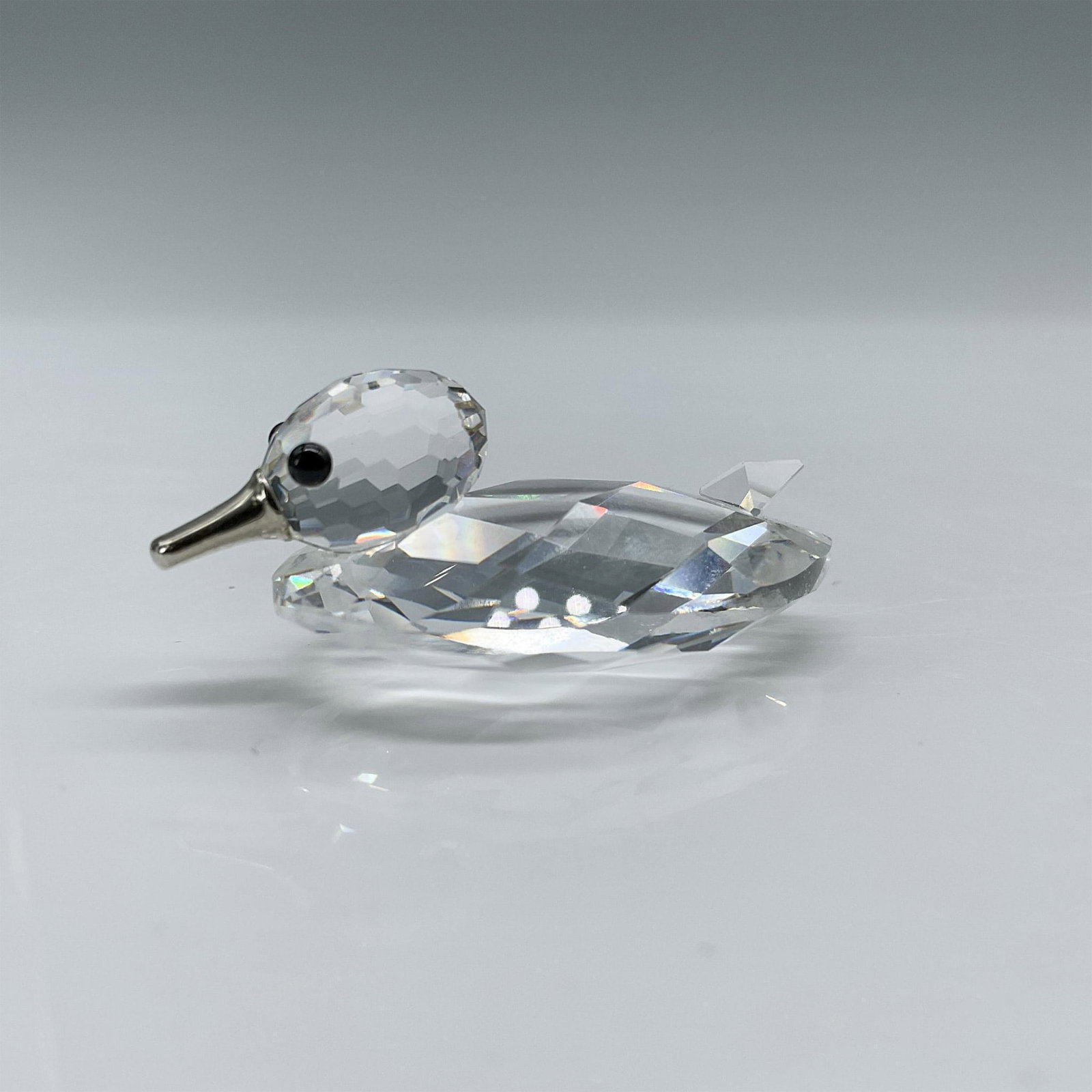 Swarovski Crystal Figurine, Duck with Silver Beak: Clear faceted crystal body, this duck has a silver beak and jet crystal eyes. Square Silver Crystal SC acid mark. Includes original box: 2.5"W x 3"H. Artist: Max Schreck Issued: 1980-1988 Dimensions: 
