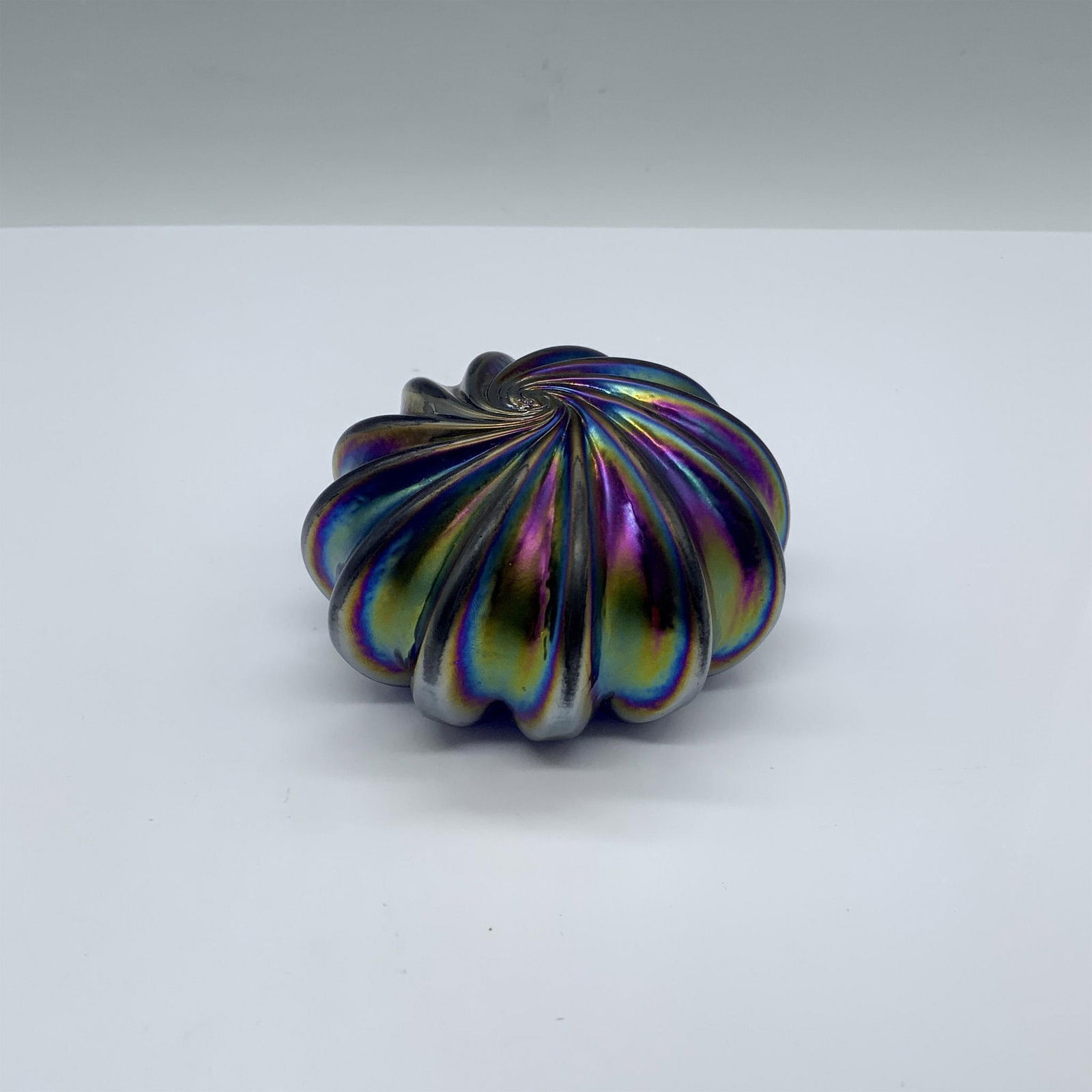 Levay Iridescent Studio Art Glass Paperweight: Gorgeous iridescent ridged spiral paperweight. Levay marked on the bottom. Artist: Gary Levay Dimensions: 3.25"dia. x 1.75"H Country of Origin: United States