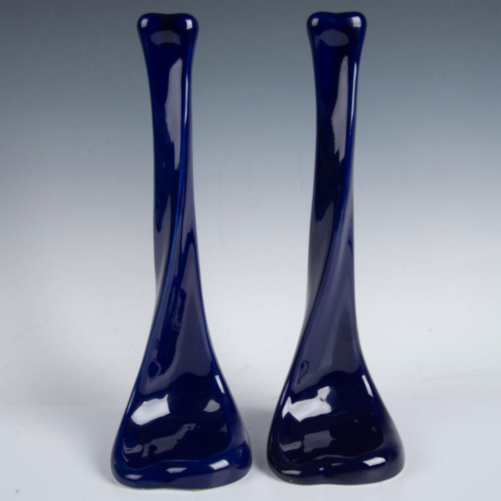 Pair of Elsa Peretti for Tiffany & Co Blue Candlesticks: Gorgeous pair of original Elsa Peretti for Tiffany & Co Bone series Modernist candlesticks in ultramarine glazed finish ceramic. Stamp carving on underside base of each candlestick: E. Peretti for Tif
