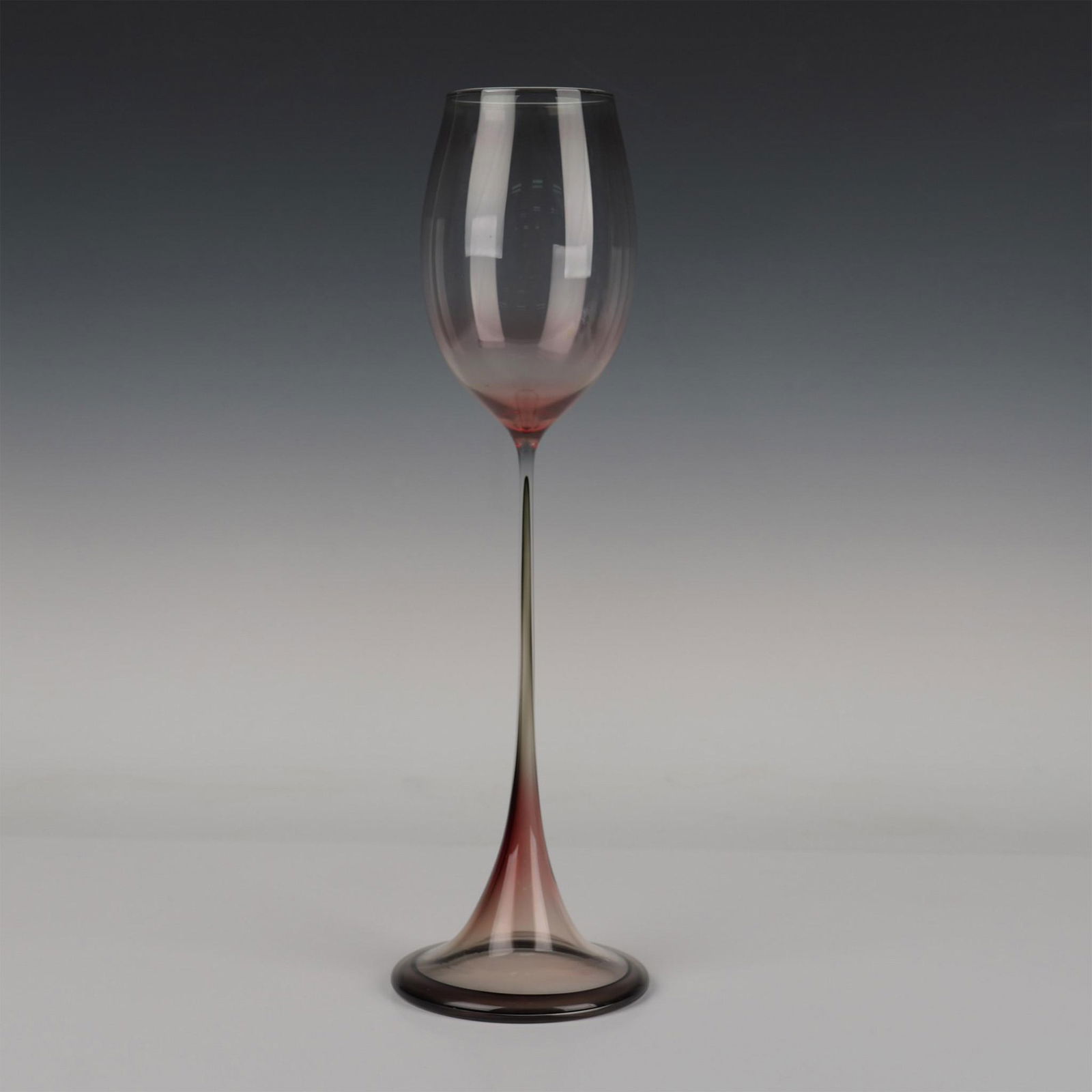 Orrefors by Nils Landberg Tulpan Vase: Dark pink with a flared base and a goblet formed top. Orrefors Expo etched on the base. Artist: Nils Landberg Issued: 1950s Dimensions: 5"W x 16.5"H Manufacturer: Orrefors Country of Origin: Swed
