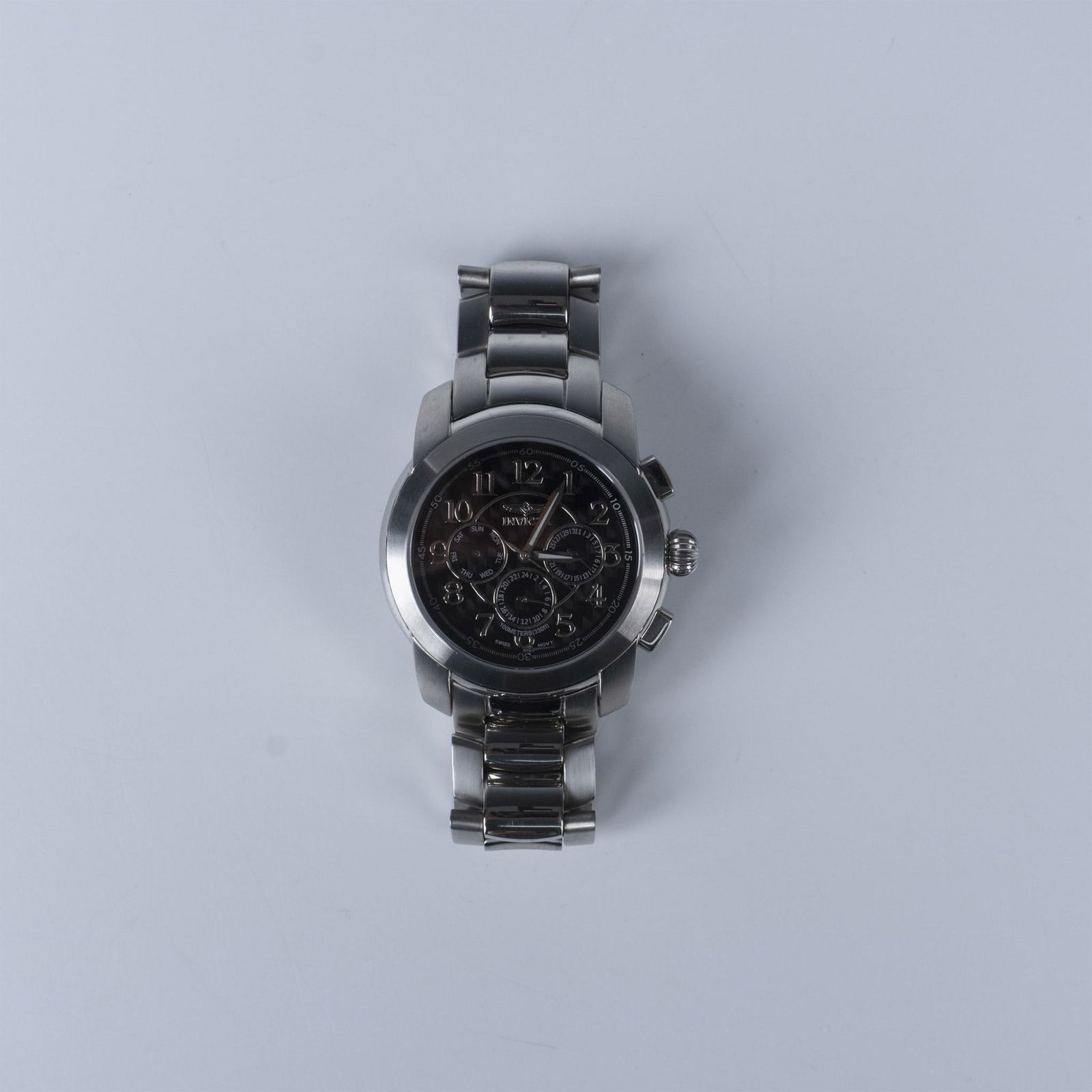 Invicta Model No. 3348 Extreme Chronograph Watch: This watch has a stainless steel case with crown and two buttons. The face features an analog dial with three sub-dials. It has Swiss movement, sapphire crystal, and is 100m water resistant. Dimension