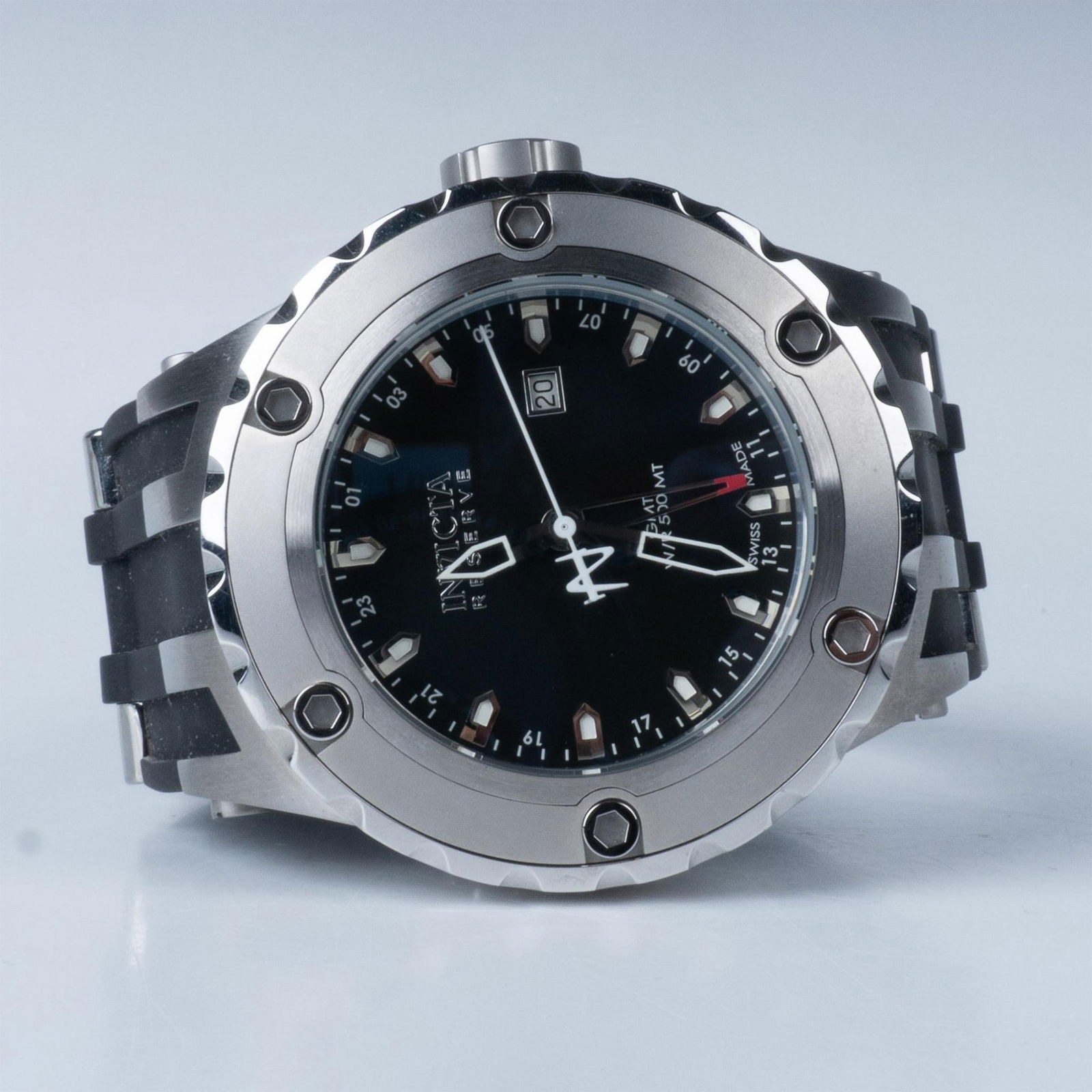 Invicta Model No. 6182 Reserve Collection Watch: This watch has a stainless steel case and a black dial with luminous hands and index hour markers, and minute markers, GMT, Flame Fusion crystal, and Swiss quartz function. It is water resistant 500m