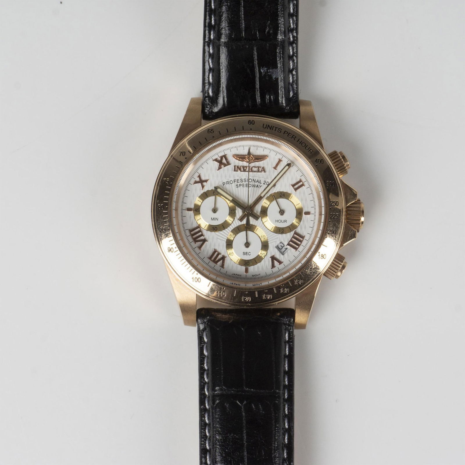 Invicta Professional Speedway 9955 Chronograph Watch: This watch has a rose gold plated stainless steel case, white dial, gold 60 second, 30 minute and 24 hour sub-dials, mineral crystal face, and Japan movement. Water resistant 200m. The total length wi