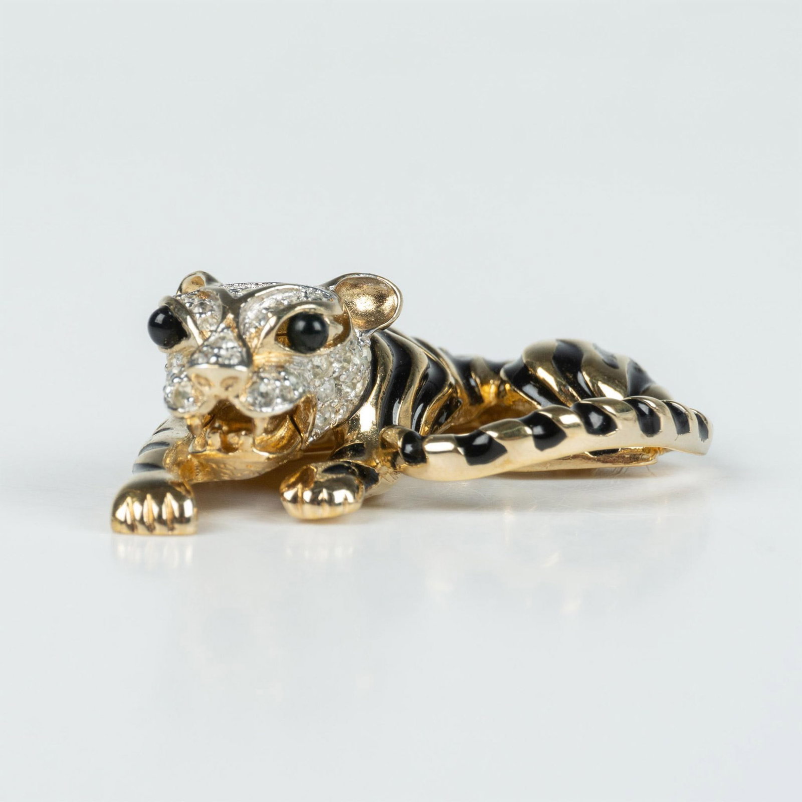 Panetta Gold Metal and Crystal Tiger Brooch Pin: Gold tone tiger brooch with black stripes and clear round crystals. Panetta hallmark on the back. Dimensions: 1.25"L x 2"W