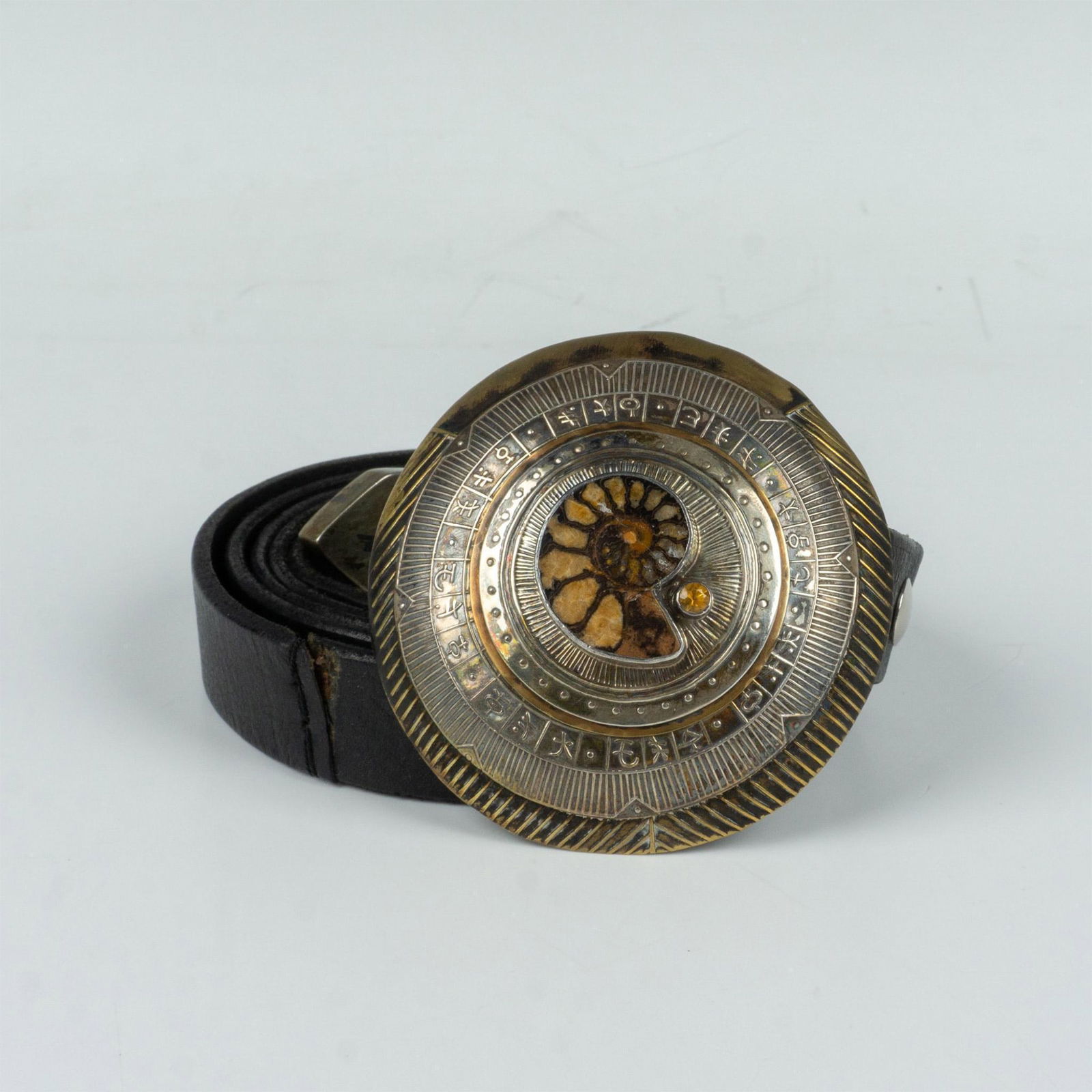 Tabra Mixed Metal Ammonite Fossil Belt: Tabra Tunoa is an internationally known jewelry artist and many of her pieces are one of a kind. The large 3"dia. buckle has a mixed metal construction with a small citrine stone and ammonite fossil.