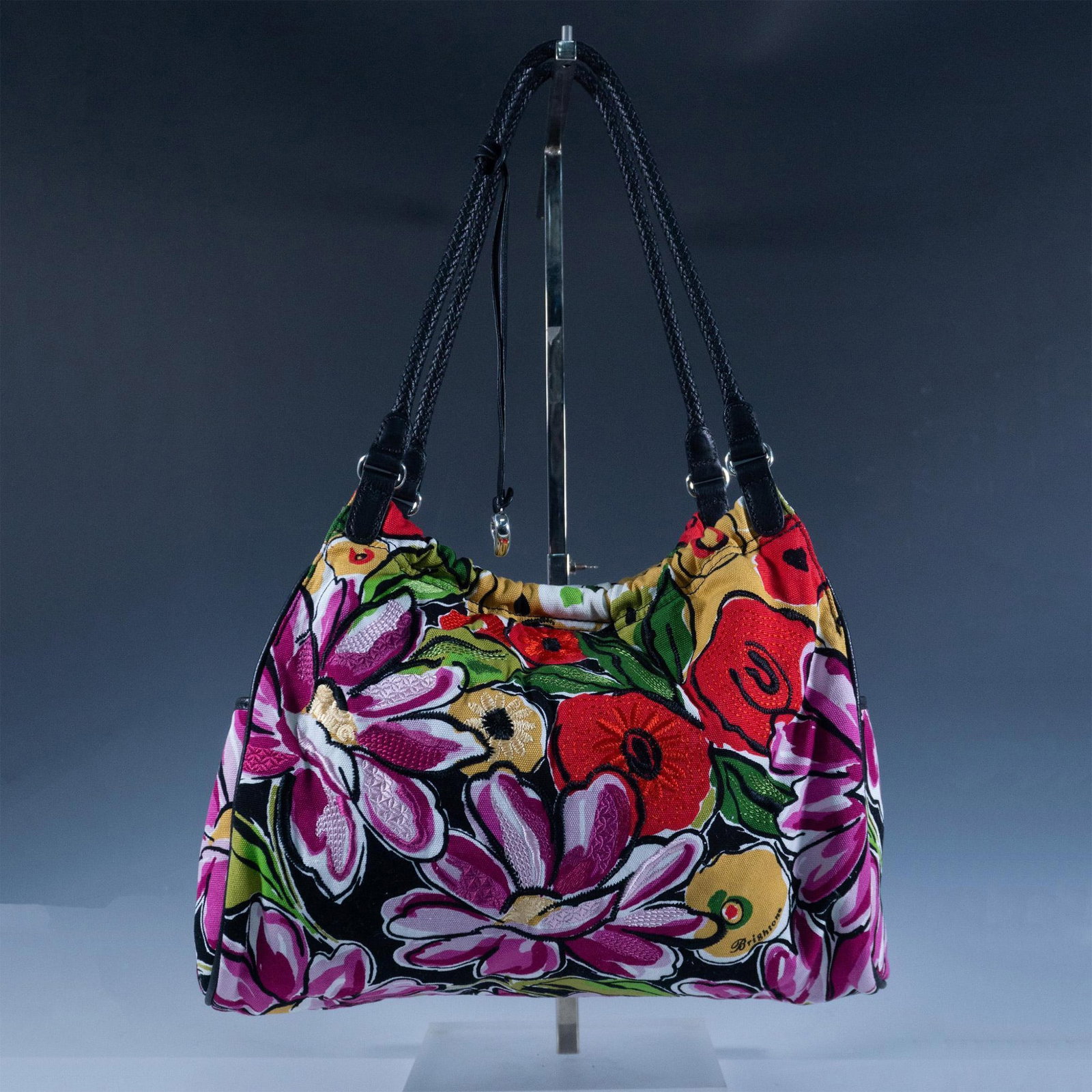Brighton Embroidered Canvas Shoulder Bag: This colorful bag features bright bold flowers with magnetic closure that opens to fabric lining with pockets. Black leather braided shoulder strap. Brighton embossed number U099318. Issued: 21st cent