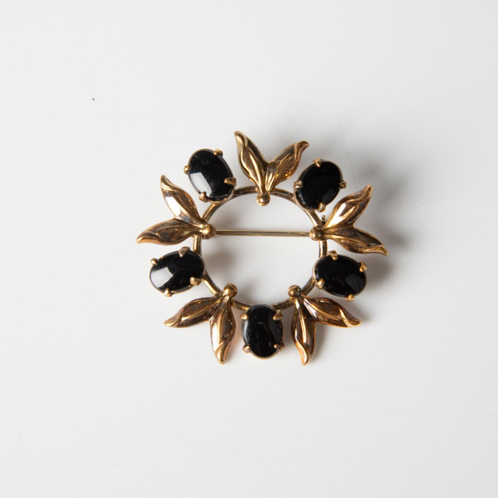 Amco 12K GF Brooch with Black Stones: 12k gold filled brooch with black stones. Amco hallmark on the back. Dimensions: 1.5"dia.