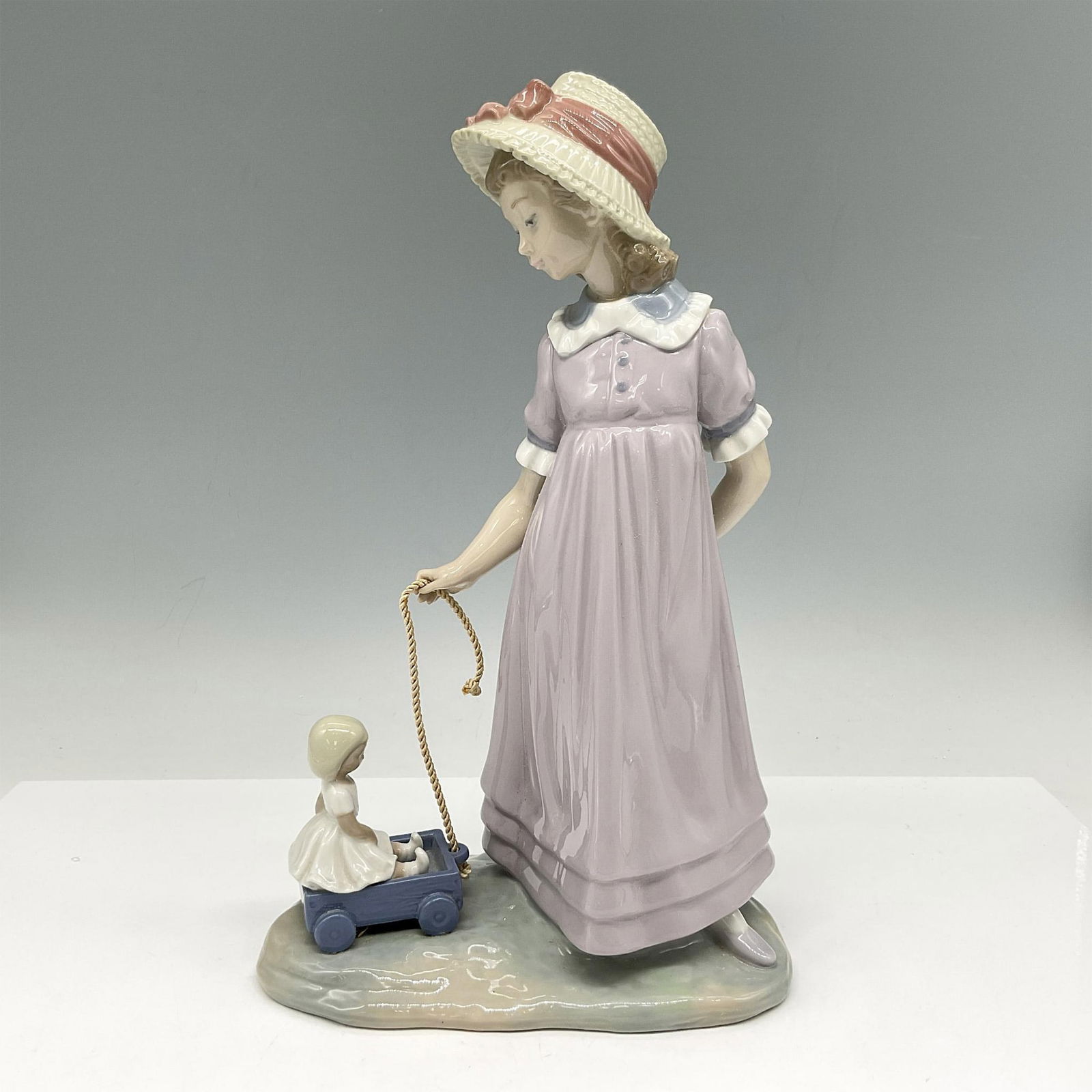 Girl with Toy Wagon 1005044 - Lladro Porcelain Figurine (1 of 5)