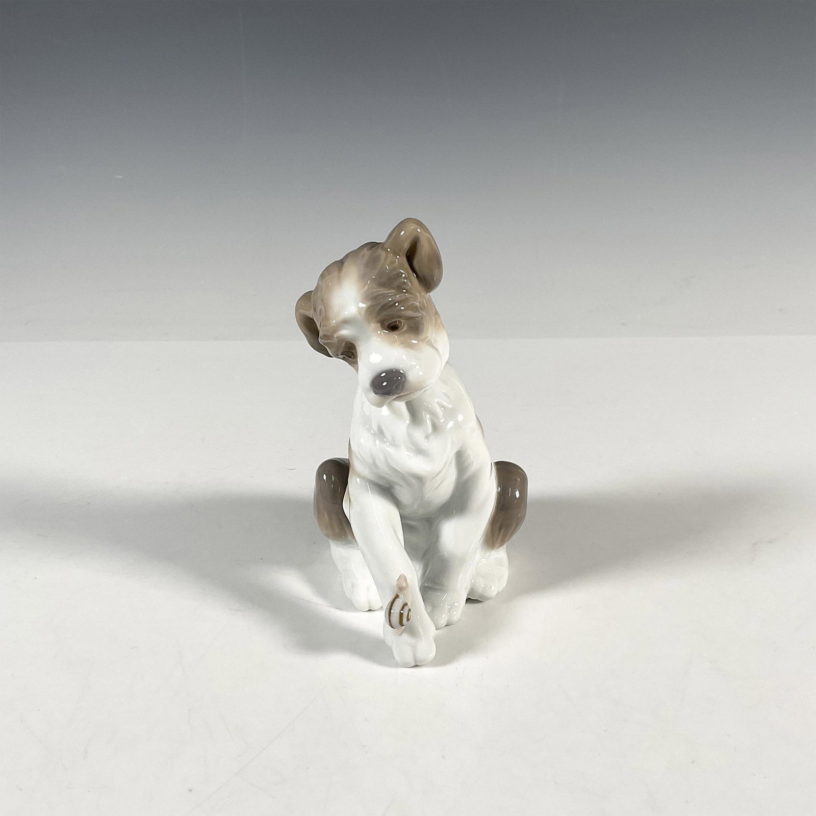 New Friend 1006211 - Lladro Porcelain Figurine: Glossy finish; Lladro backstamp. Includes original box 8"L x 5.25"W x 5"H. Artist: Juan Huerta Issued: 1995 - 2021 Dimensions: 5"H x 4.75"W Manufacturer: Lladro Country of Origin: Spain