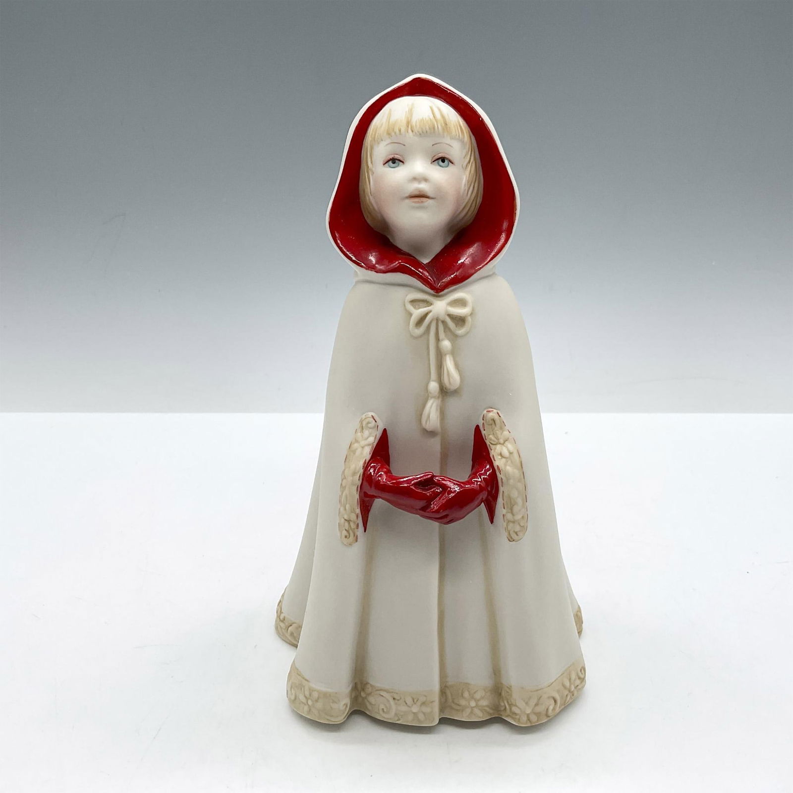 Cybis Porcelain Figurine, Little Red Riding Hood: Part of the fairytale collection series, the bisque character is handmade, and hand painted with red lining on cloak and matching red gloves. Cloak is adorned with floral detailing on hem and arm slit