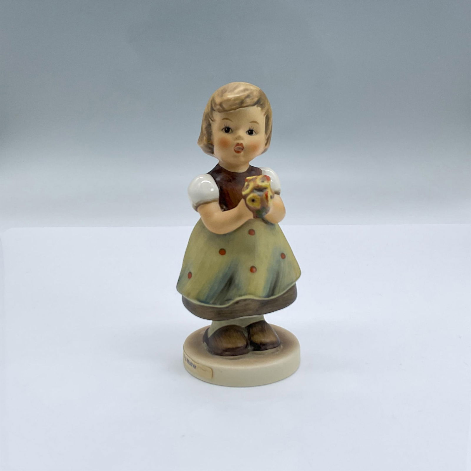 Goebel Hummel Figurine, For Mother: Beautifully hand painted porcelain of an adorable young girl holding a floral bouquet. Backstamped with Goebel Hummel W. Germany Issued: 1960 Dimensions: 2.5"L x 2.25"W x 5.25"H Manufacturer: Goebel H