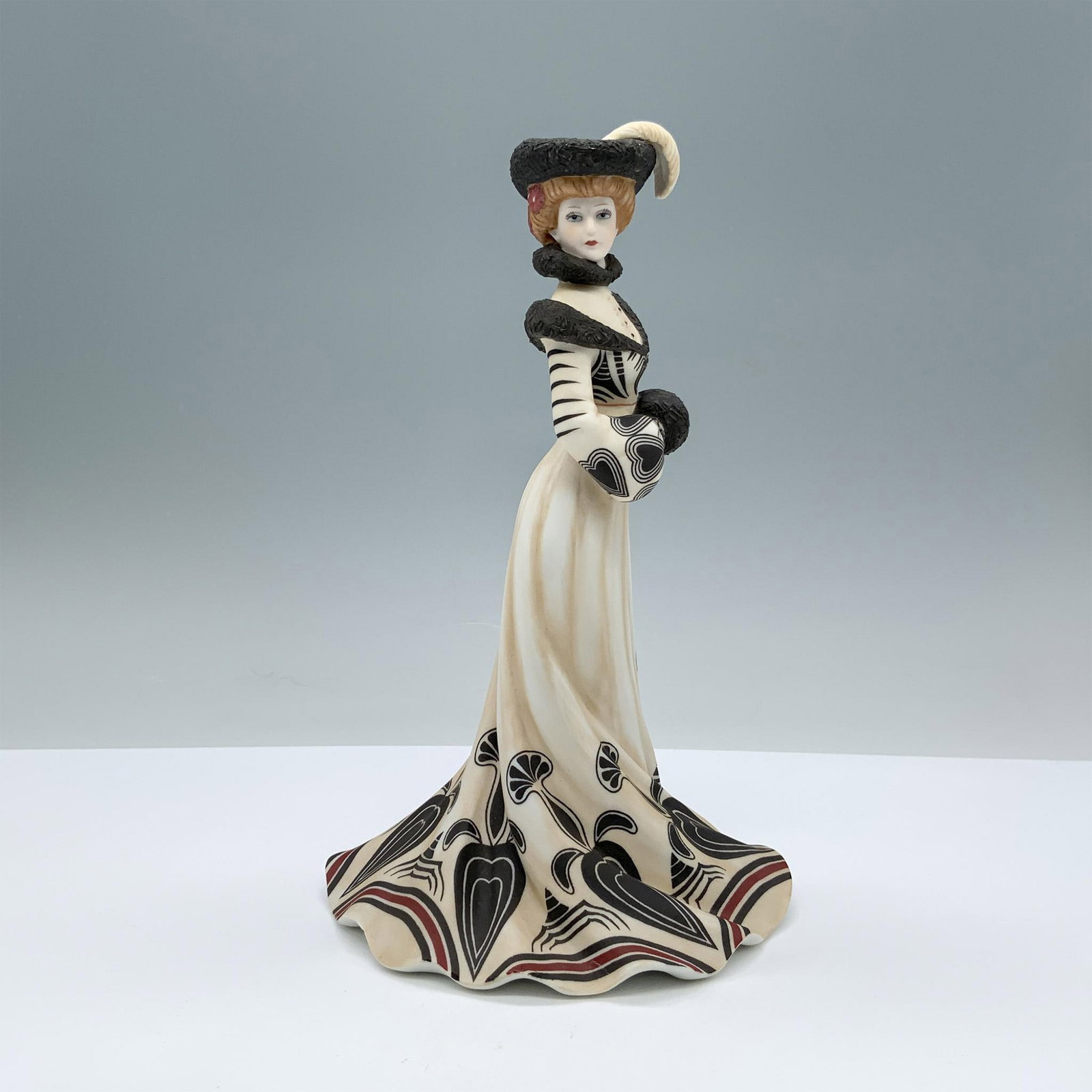 Lenox American Fashion Figurine, Tea At The Ritz: Finely decorated matte porcelain lady figurine with Lenox backstamp on the bottom. Issued: 1984 Dimensions: 4.25"L x 5.25"W x 8.5"H Manufacturer: Lenox