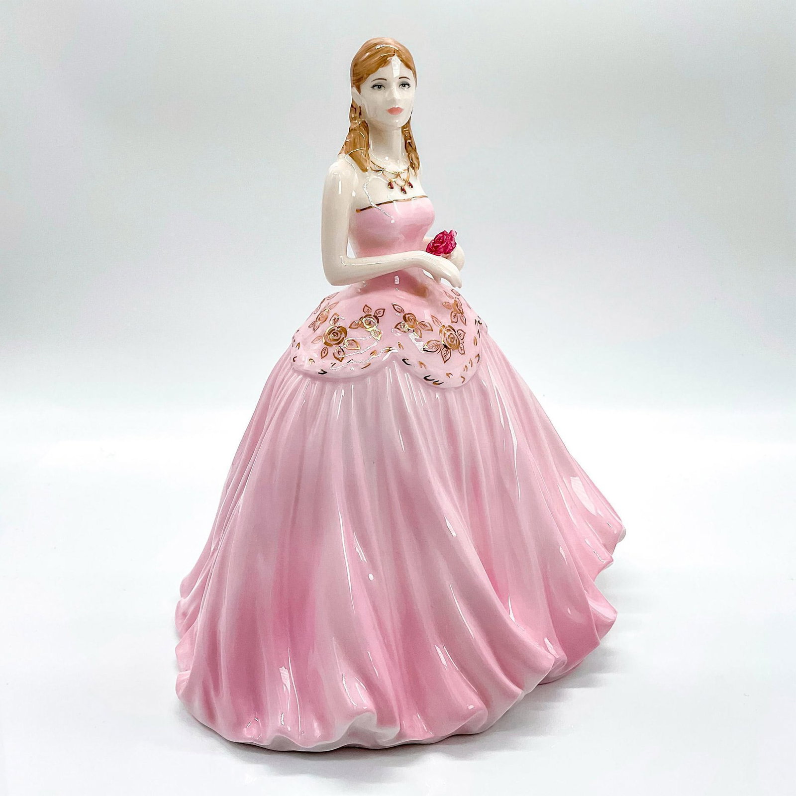 Coalport Figurine, Forever Yours: Limited edition bone china that was produced in the year of the 50th anniversary of the coronation; collectors edition. Depicts lady in a soft pink strapless dress decorated with gold gilt flowers; go