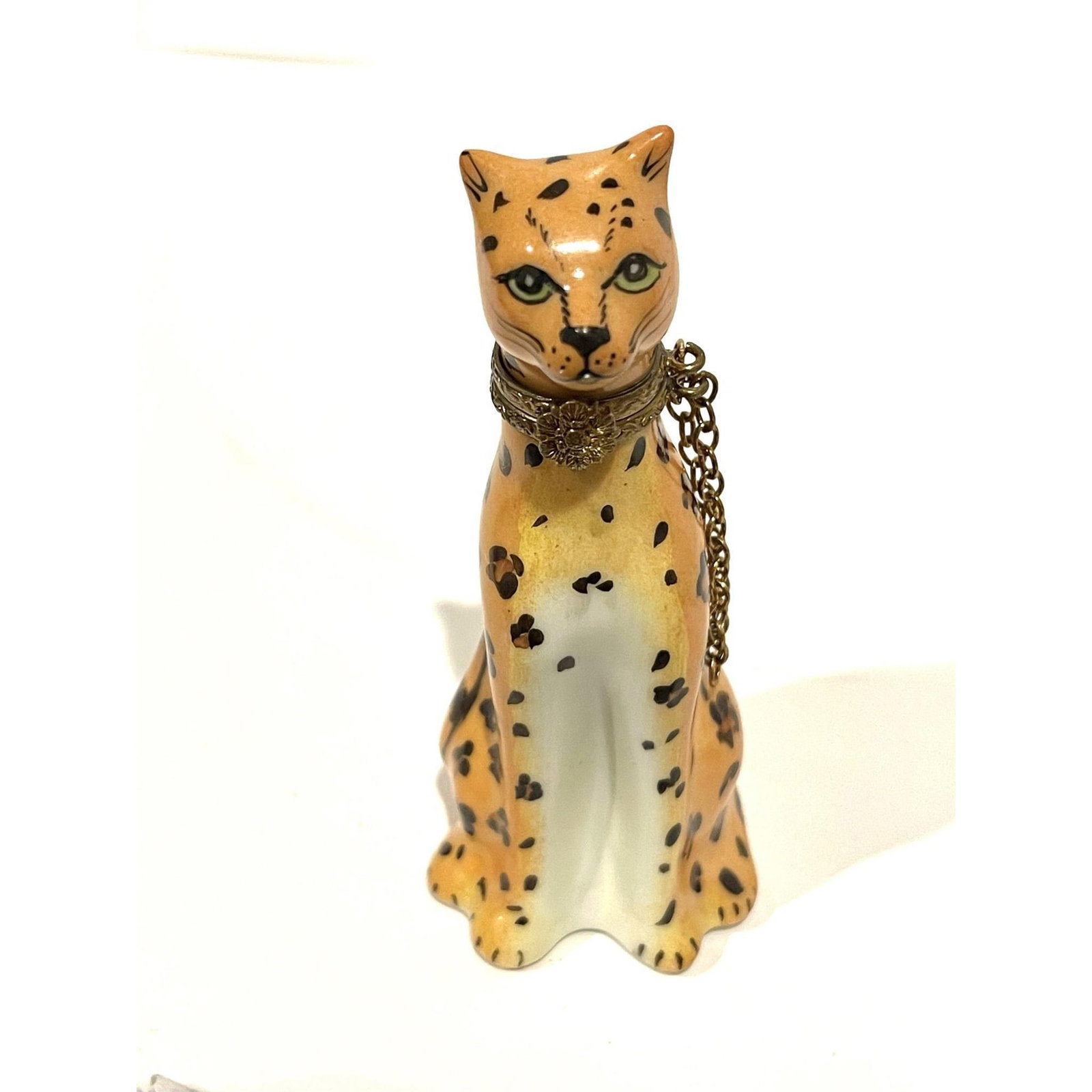 Rare Limoges France Porcelain Keepsake, Leopard Signed: Rare, stylized and sleek. Intricately detailed seated realistically hand painted Leopard, finished with a gilt trim collar replete with dangling chain and floral hinged clasp. Peint Main Limoges Franc