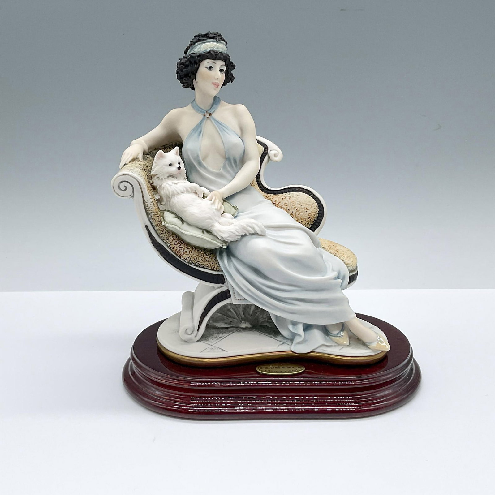 Florence Giuseppe Armani Figurine, Marianne 135C: Crafted for the 1997 The Society Members Figure members. Hand painted figure of a dark hair beauty, in a long sky-blue gown, lounging on a chaise with a furry white cat. The figure is placed on a wood
