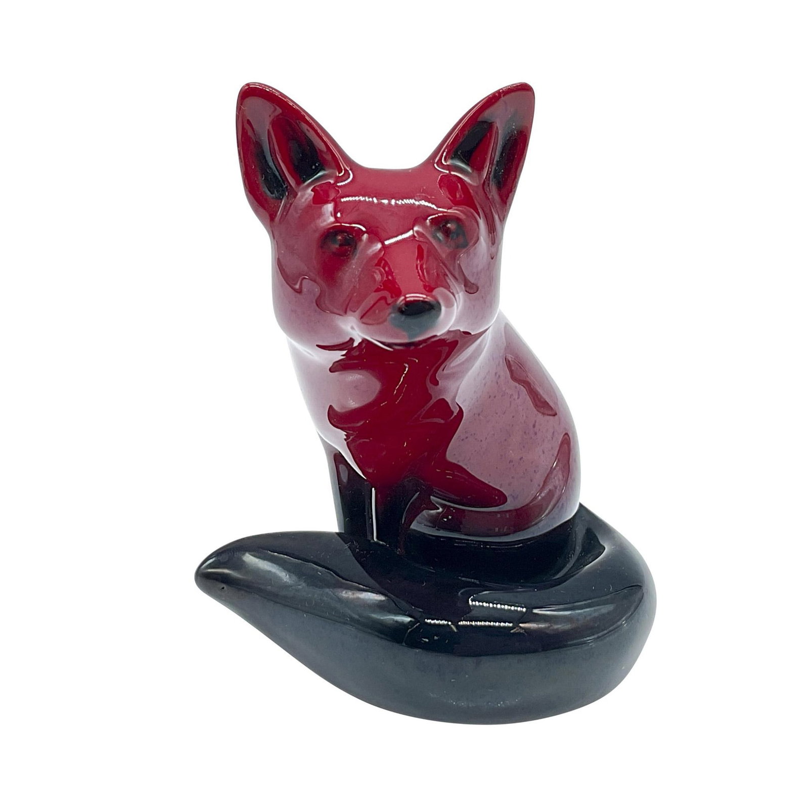 Royal Doulton Flambe Figurine, Fox Seated HN147B: Flambe glaze. Presenting a rich red color and black accents. Royal Doulton Flambe backstamp. Issued: 20th century Dimensions: 3.5''L x 3''W x 4.25''H Manufacturer: Royal Doulton Country of Origin: Eng