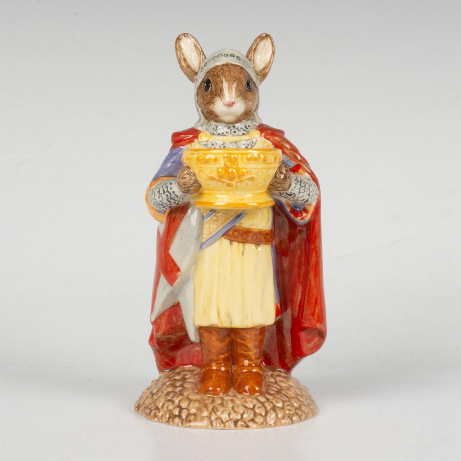 Sir Galahad DB299 - Royal Doulton Bunnykins: A figure of the fictional character, a knight of the Round Table, wearing armor, a crested helmet, long red cape, and holding the Holy Grail. Part of the Arthurian Legends series. This item comes with